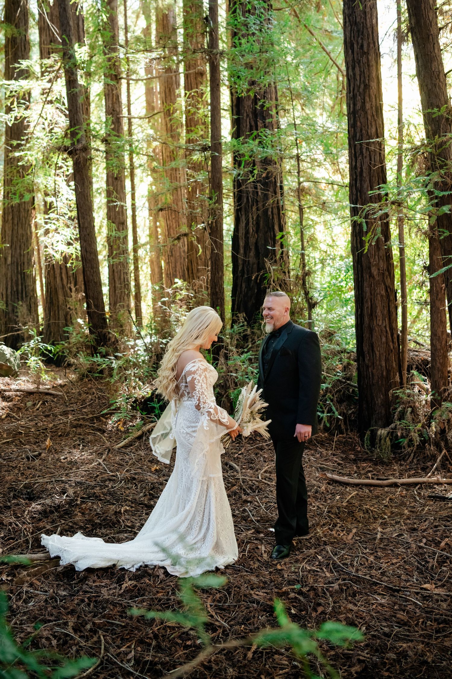 A romantic wedding photoshoot captured in a majestic redwood forest with soft natural lighting.