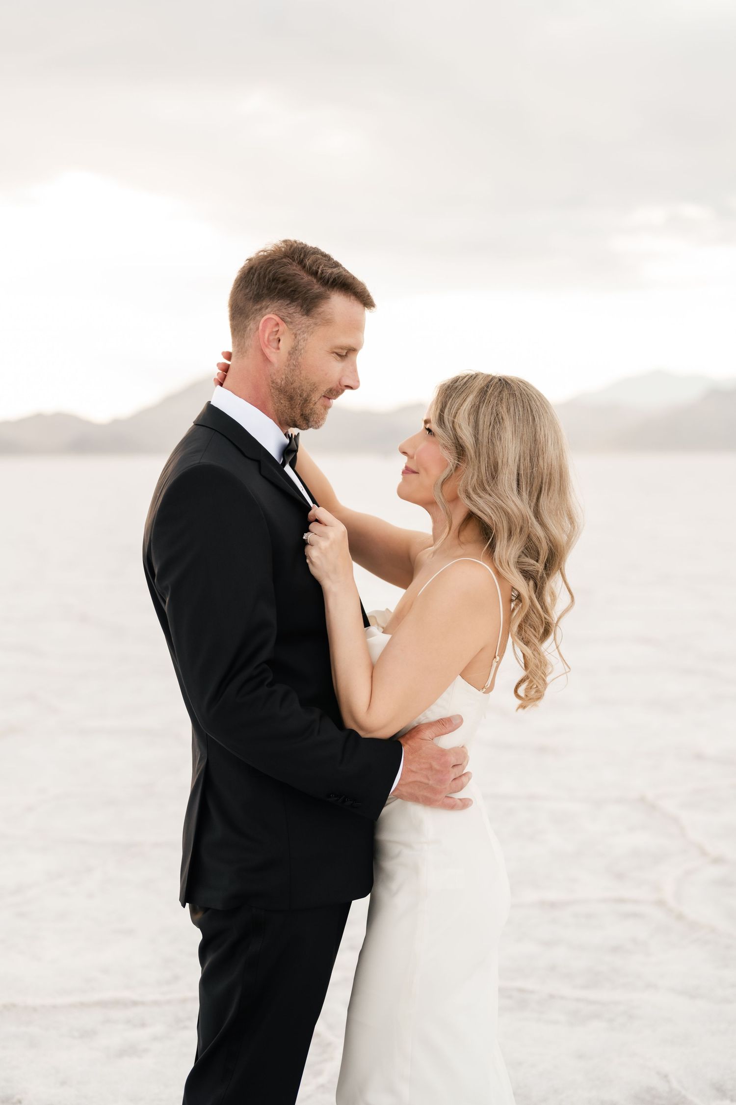Salt Flats Elopement Photographer. A romantic moment captured between newlyweds on the bright white salt flats.