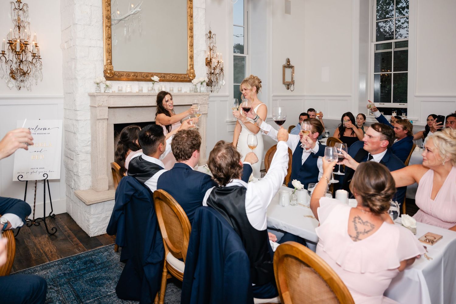 Wedding guests celebrating and laughing together at elegant reception tables.
