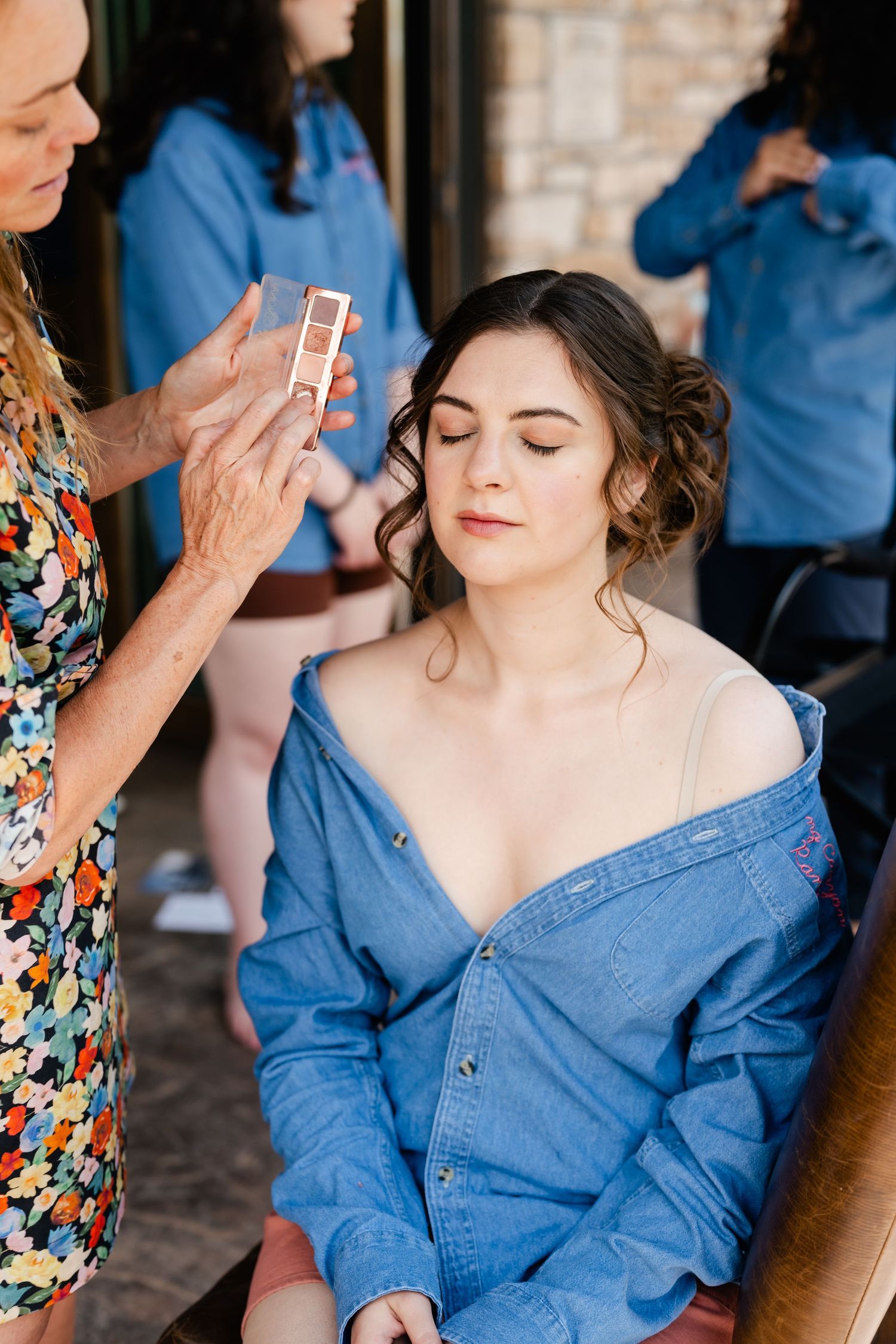 A series of getting-ready photos showing someone in a denim top having makeup applied.