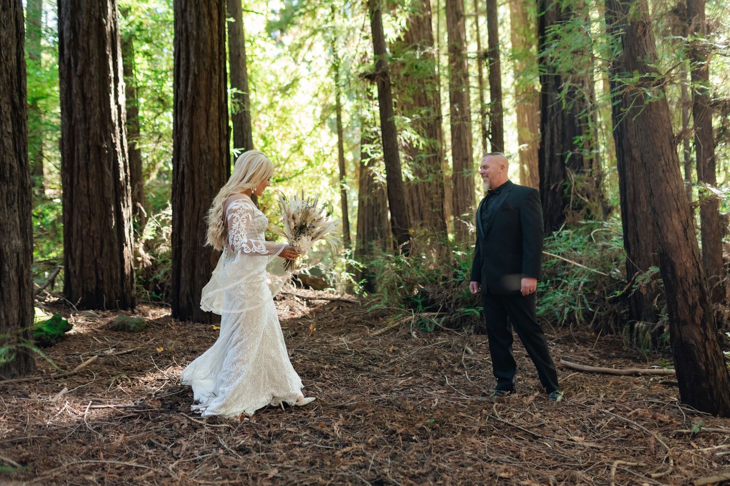 Romantic wedding photos captured in a lush redwood forest with tall trees creating a magical natural backdrop.