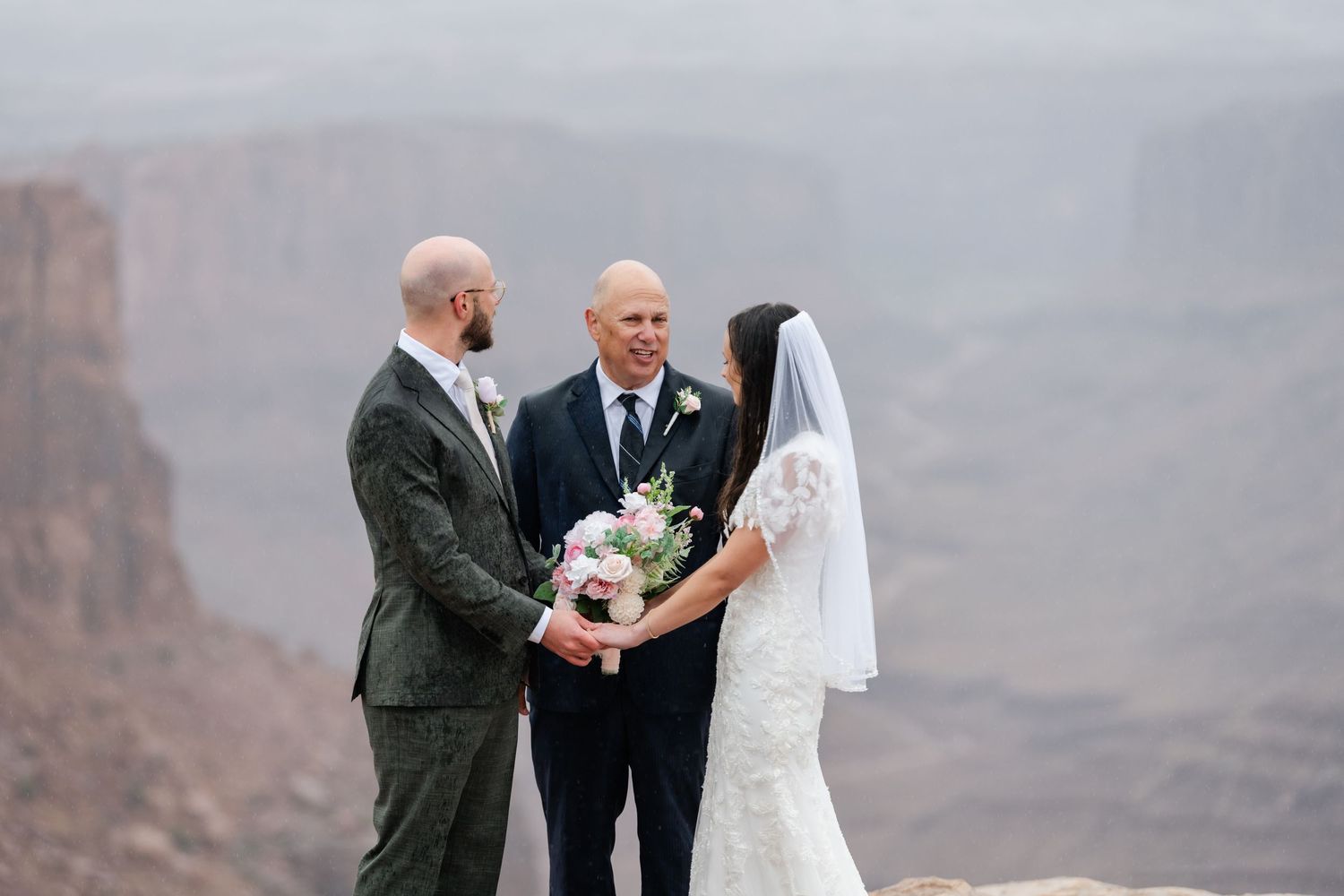 Intimate wedding ceremony photos with canyon landscapes in the background.