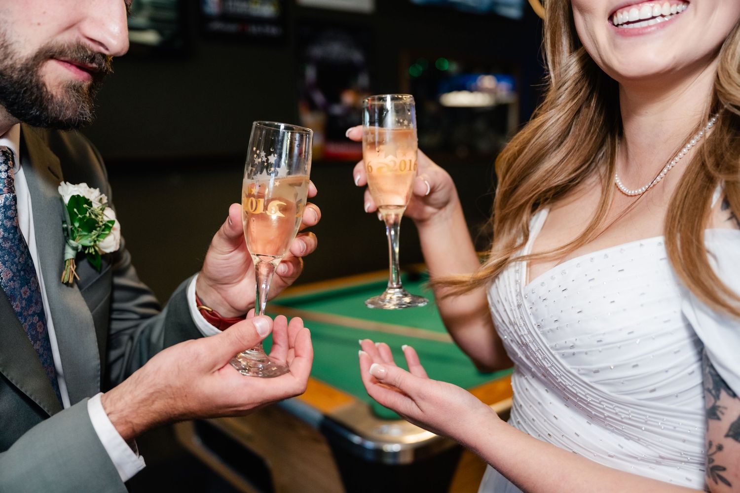 A group of people toasting with champagne glasses at a formal celebration event.