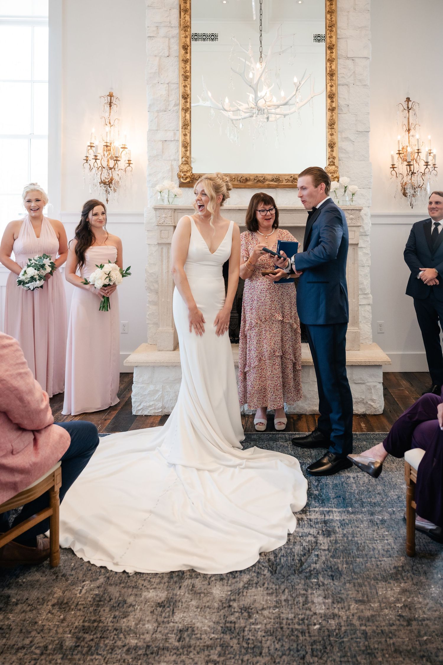 Sequence of wedding photos showing a couple dancing and twirling in an elegant white-walled room with chandeliers.