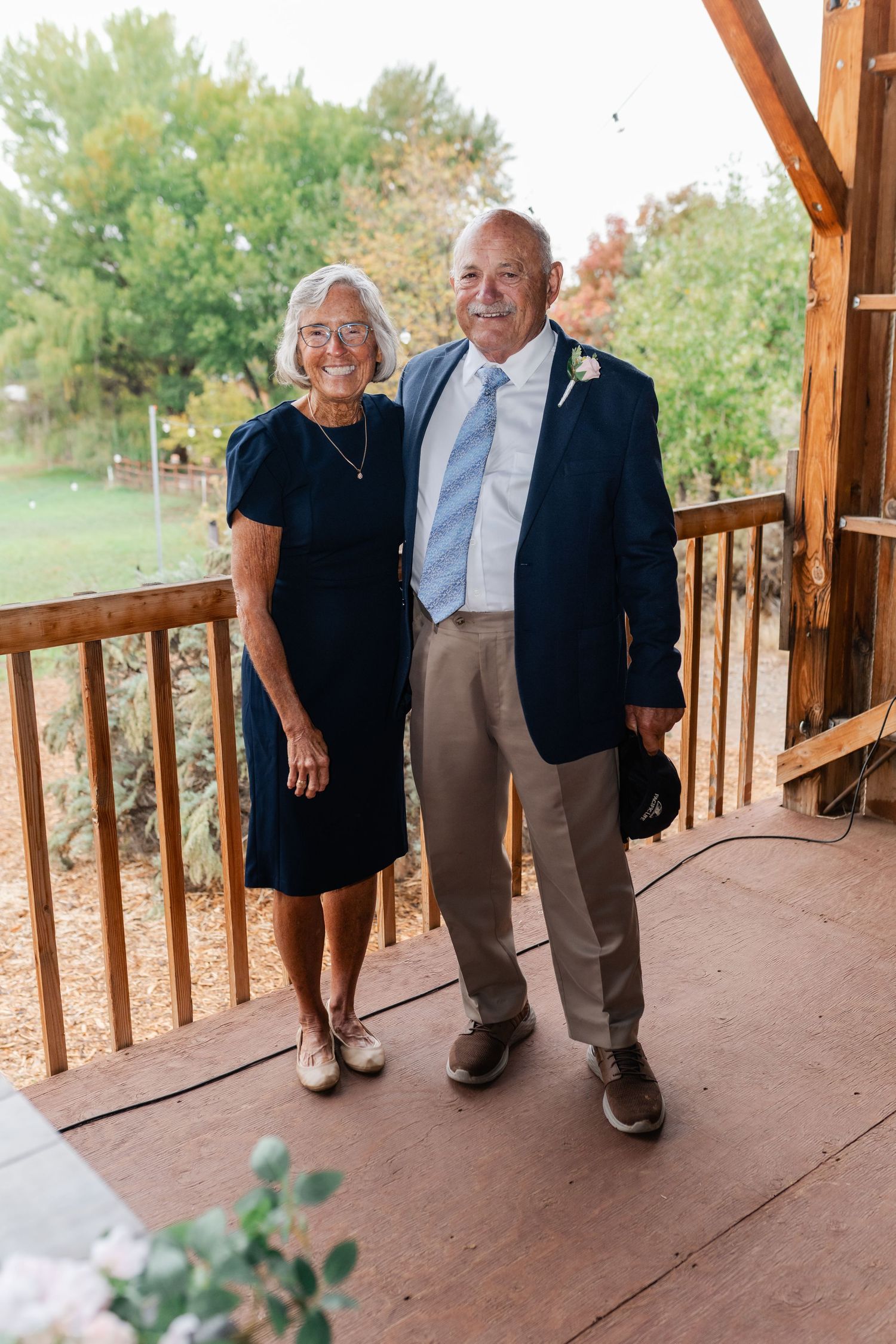 Couples dance together on a covered patio with wooden railings and mountain views.