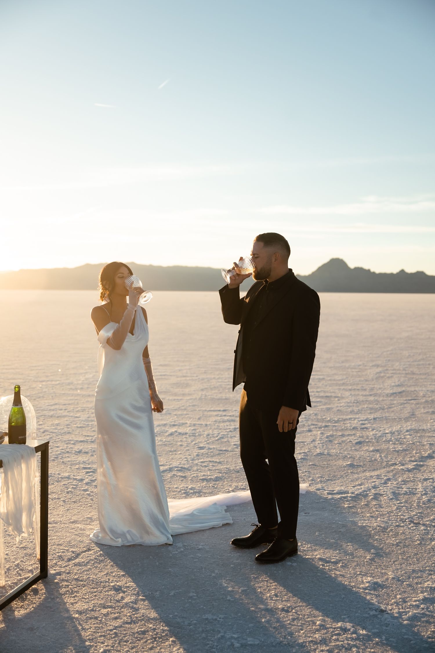 Wedding couple celebrates during ceremony on scenic salt flats.