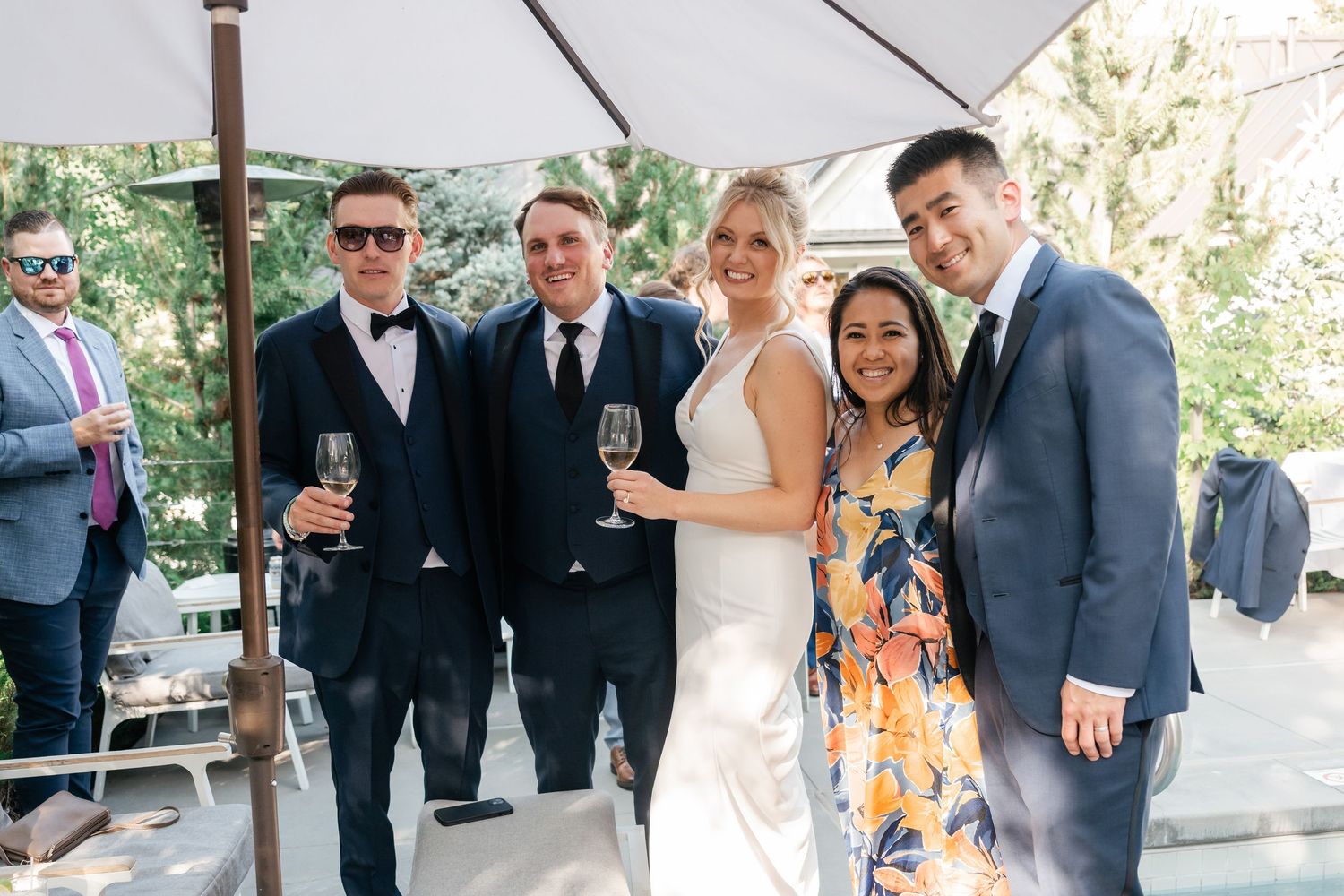 Wedding guests mingle and celebrate during outdoor cocktail reception.