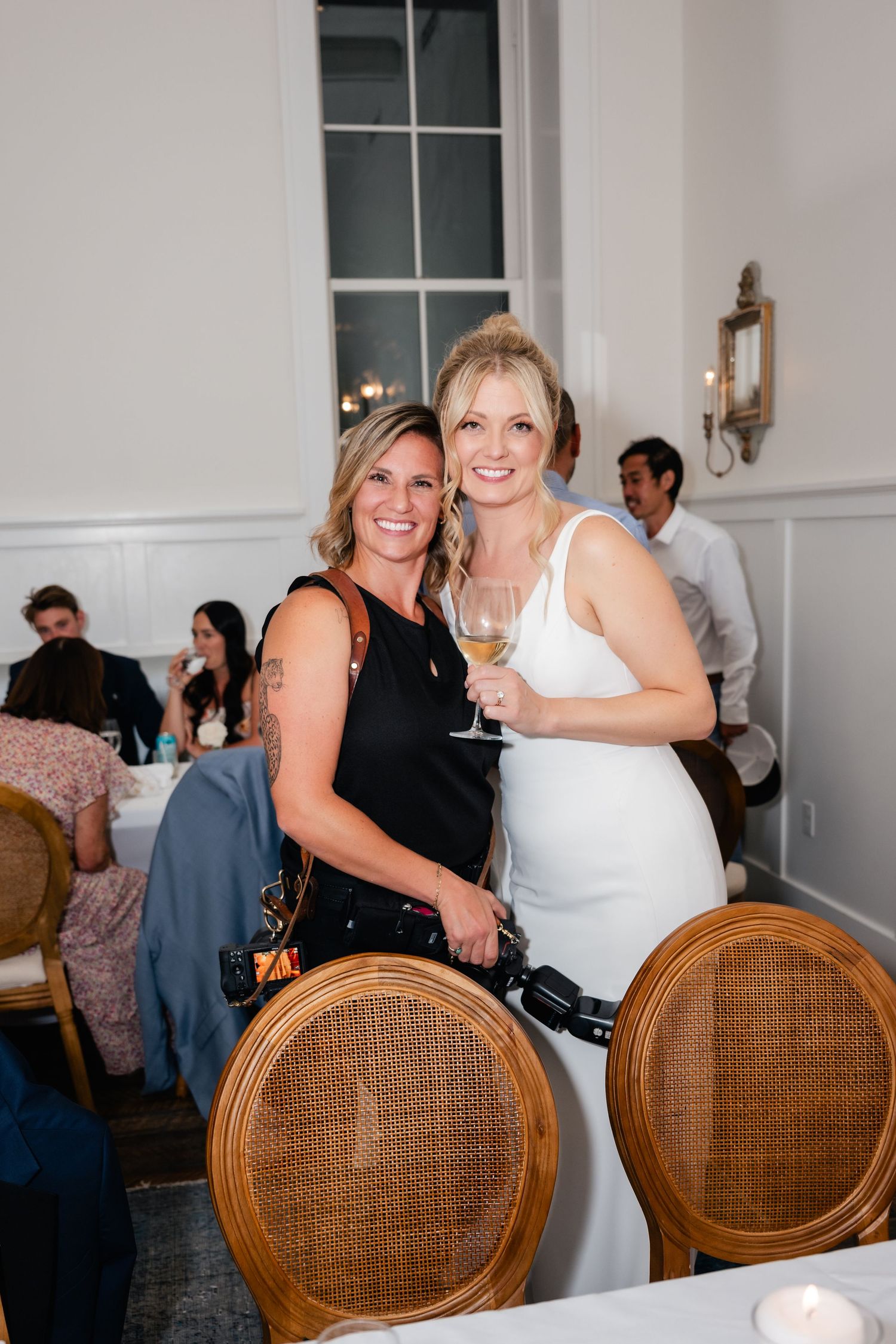 Coley Cook smiling with a bride at a Park City Wedding. Washington School House Hotel Wedding.
