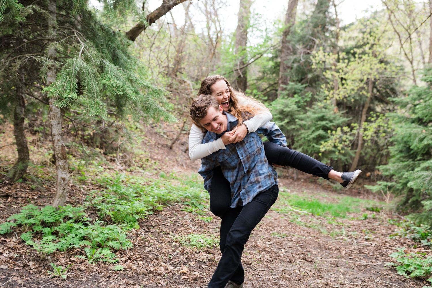 A joyful outdoor moment captured in a forest setting with natural lighting.