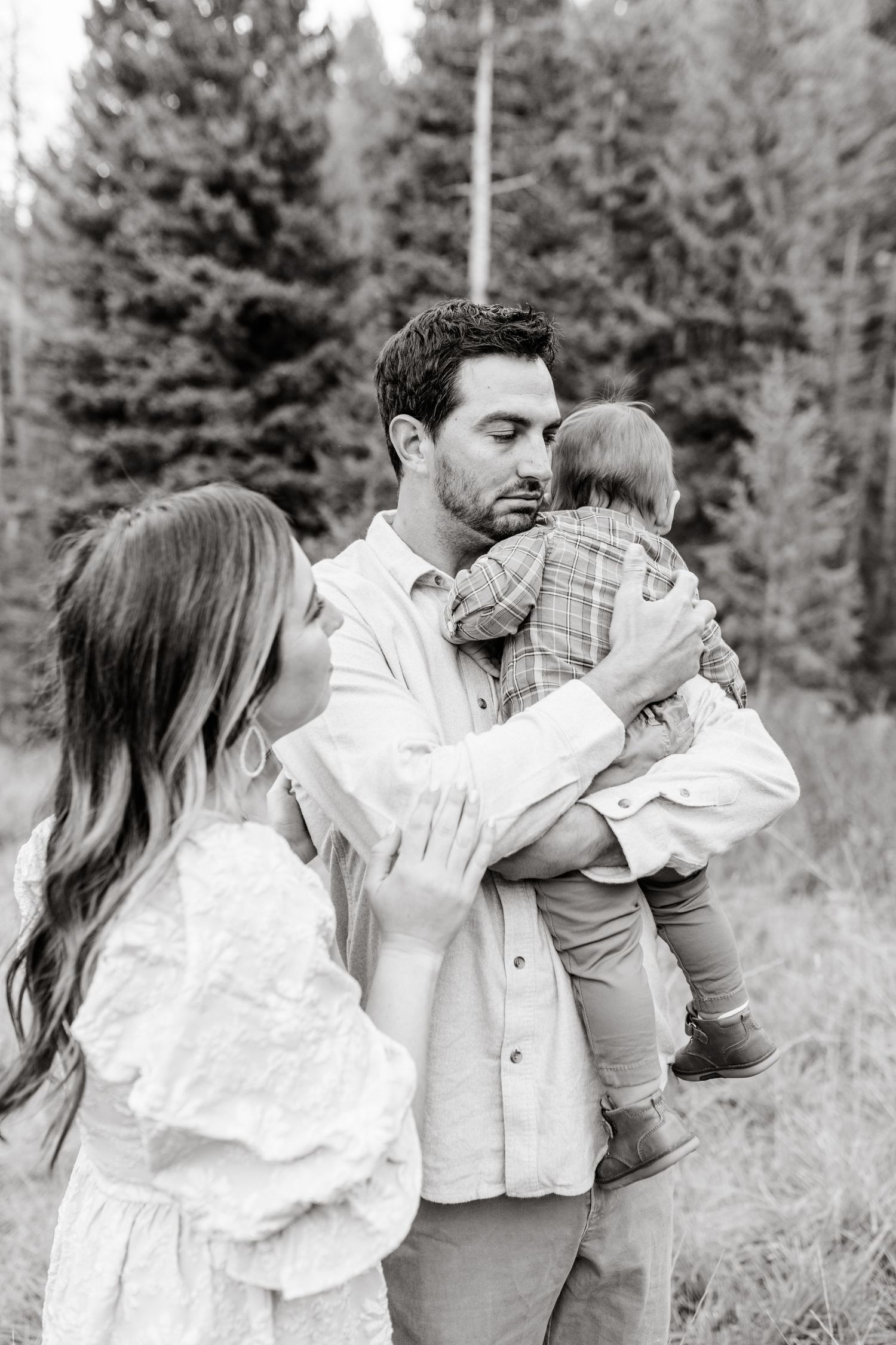 young family has a close cuddle together in American Fork Canyon for their fall family photos