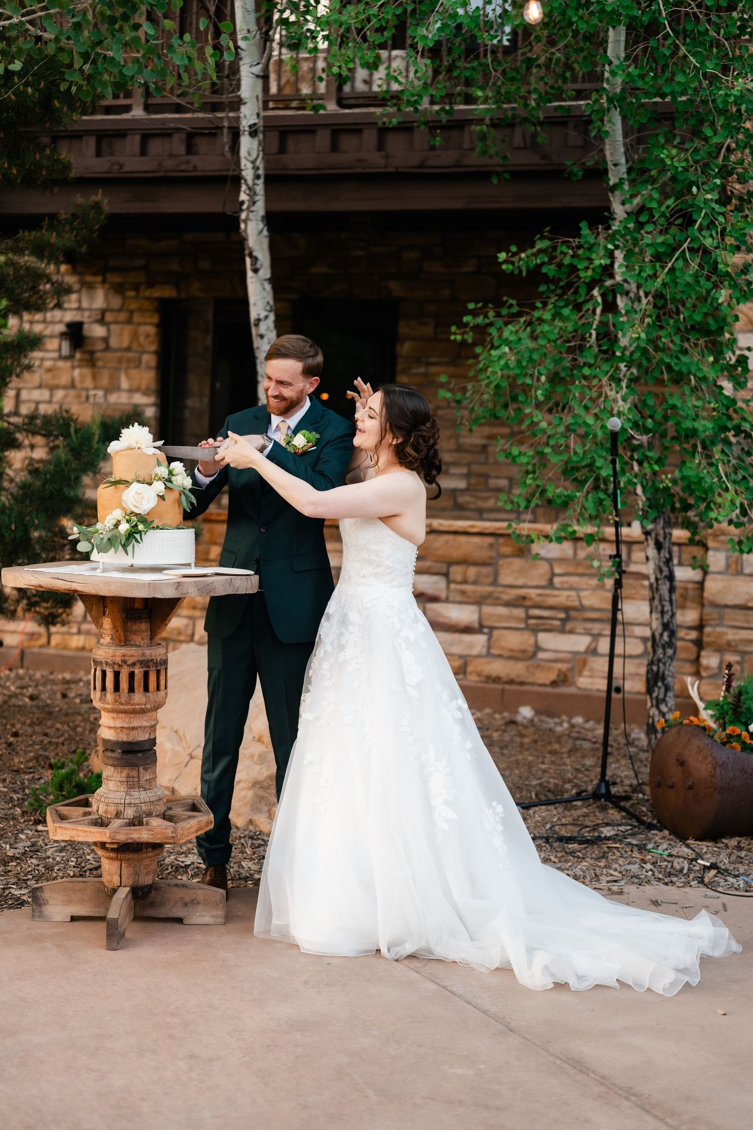 Wedding celebration moment at a rustic stone venue with decorative outdoor lighting.