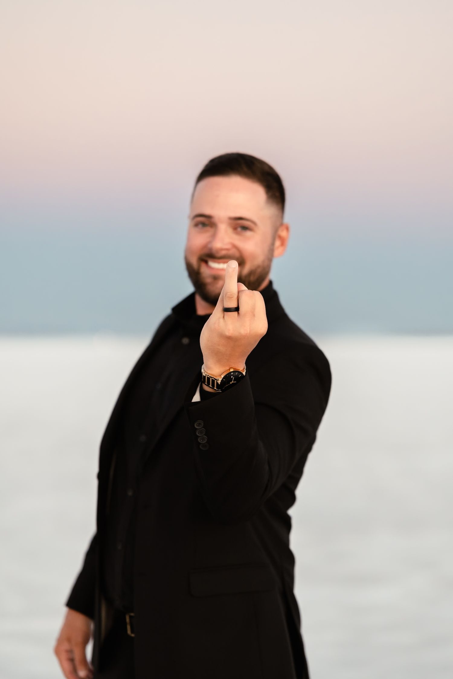 A joyful moment captured against a serene salt flat backdrop at sunset.