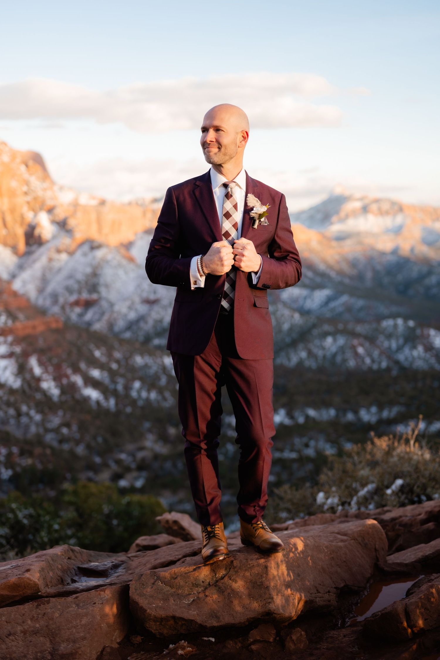 Wedding photography on a rocky mountain overlook with dramatic canyon views.