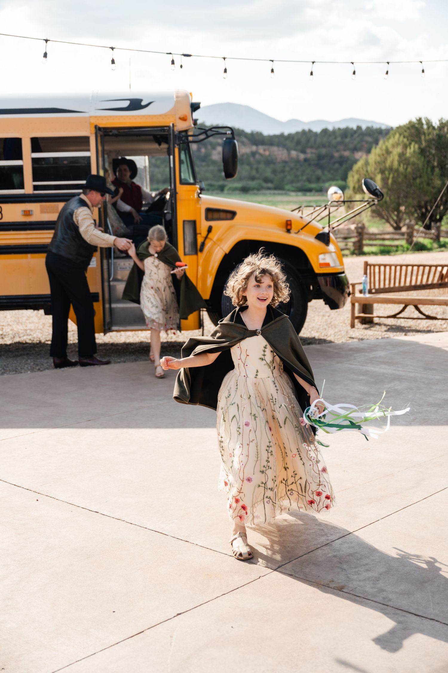 A sequence of playful dance moves shown in a series of photos with a yellow school bus in the background.