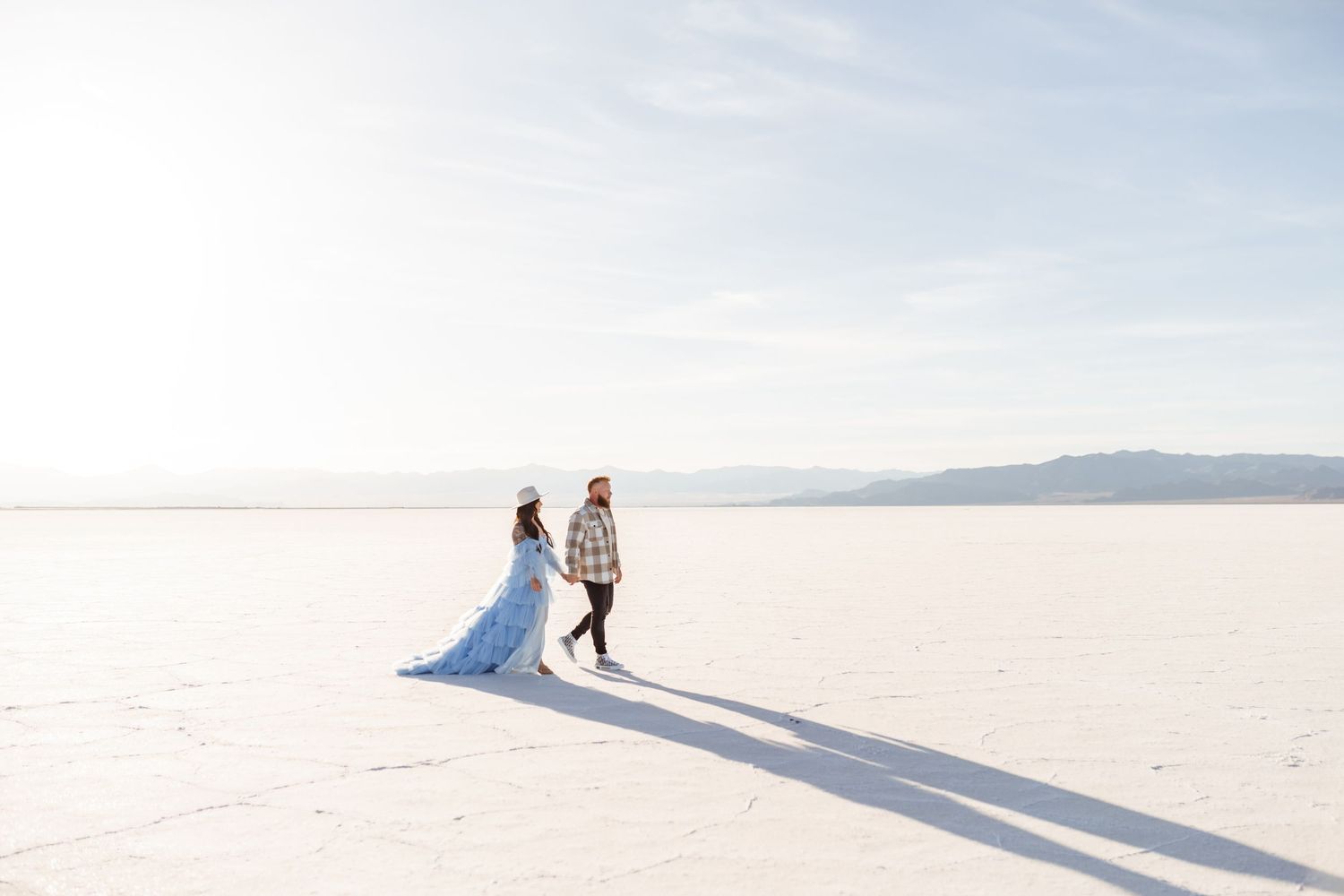 Couple holds hands during golden hour at the Salt Flats by Utah Salt Flats photographer