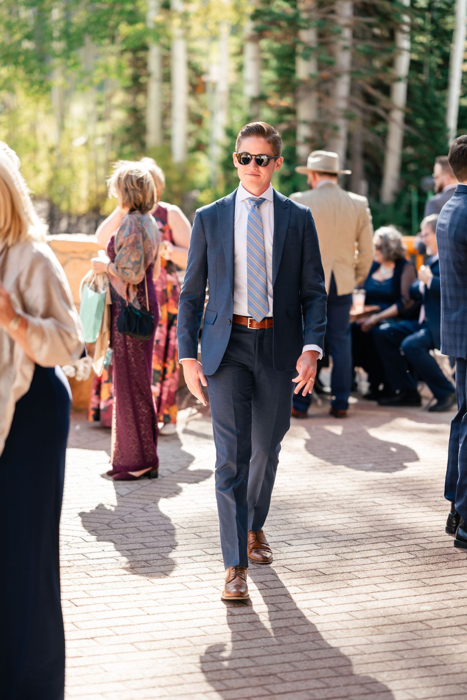 Wedding guest walking on outdoor path during daytime ceremony. Park City Wedding Photographer. Utah Wedding Photographer.