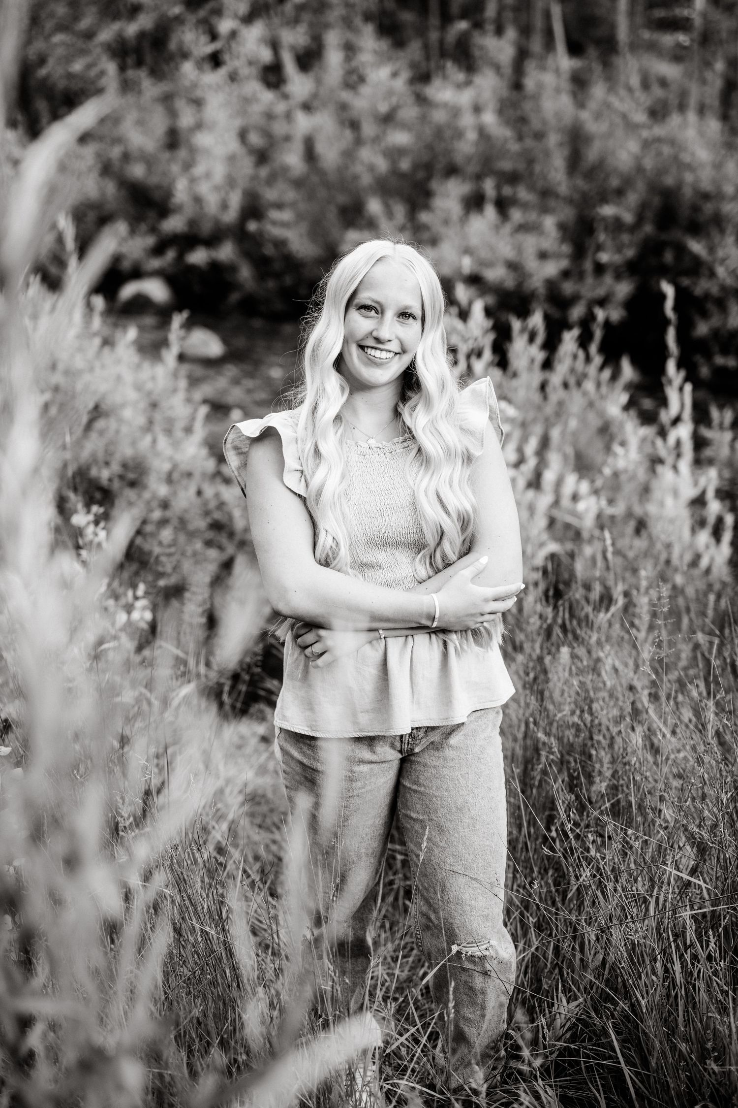 black and white smiling portrait by the creek in american fork canyon