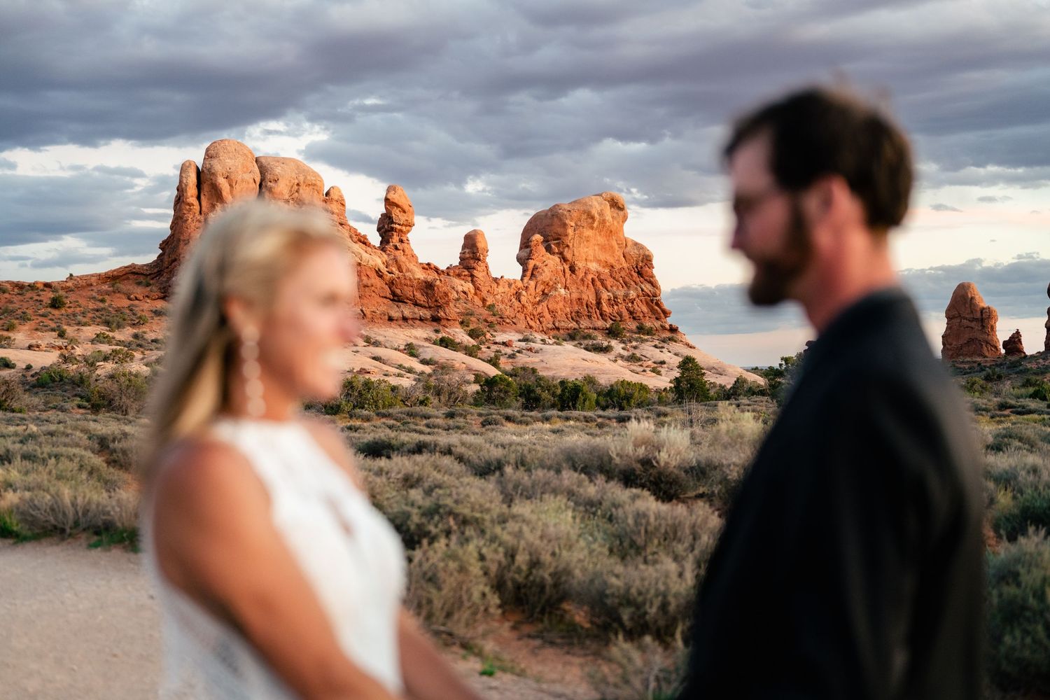 Wedding photo focused on the landscape of Arches NP by Utah Elopement Photographer
