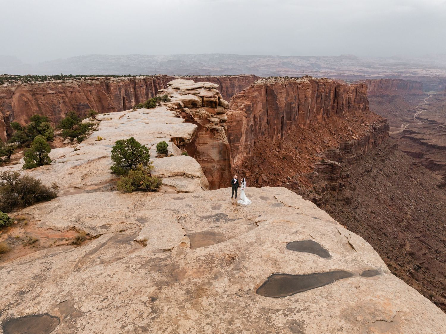 A panoramic view of red rock canyons and desert landscapes at Dead Horse Point State Park in Utah during sunset.