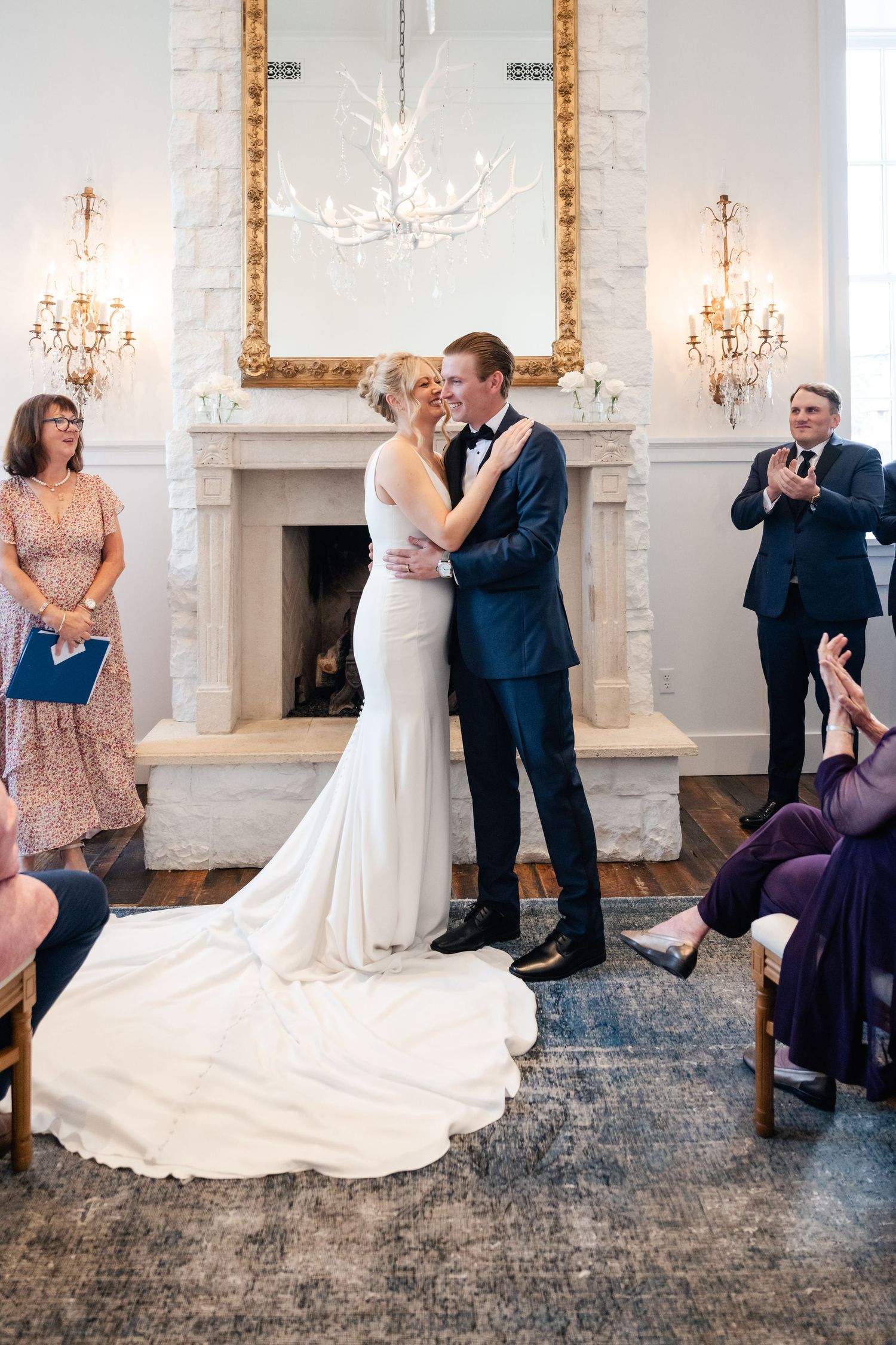 A series of wedding photos showing a couple in formal attire dancing and laughing in an elegant room with chandeliers.