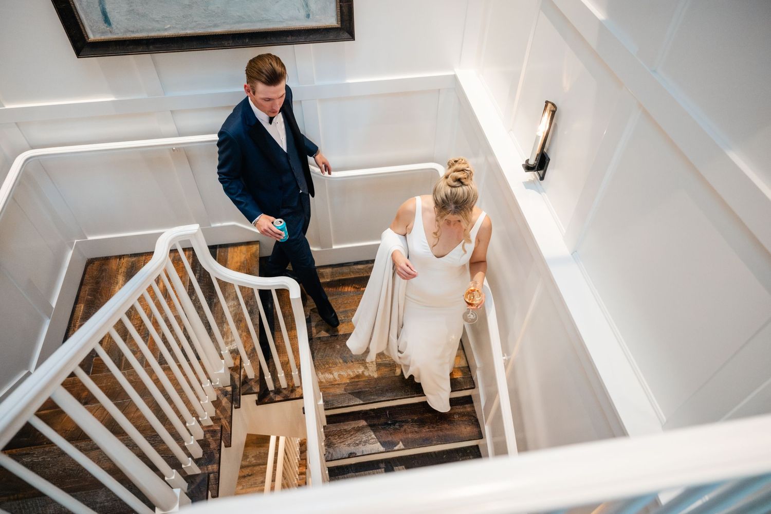 Interior staircase shot of wedding preparations in a modern white space.