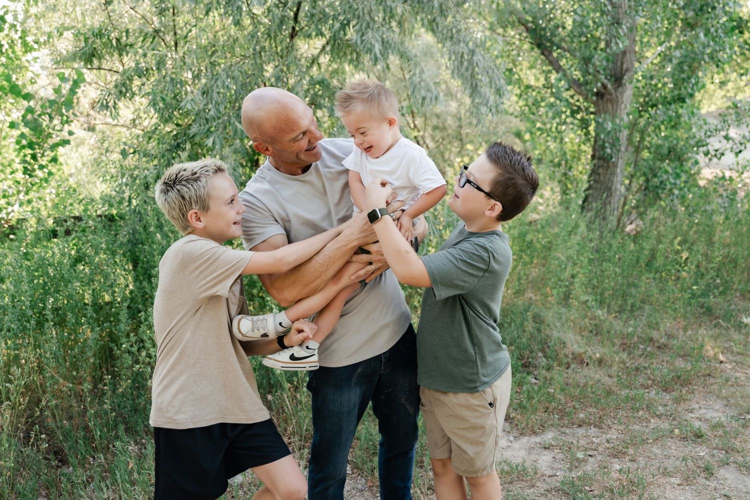 A sequence of playful moments captured in a wooded outdoor setting during a sunny day.