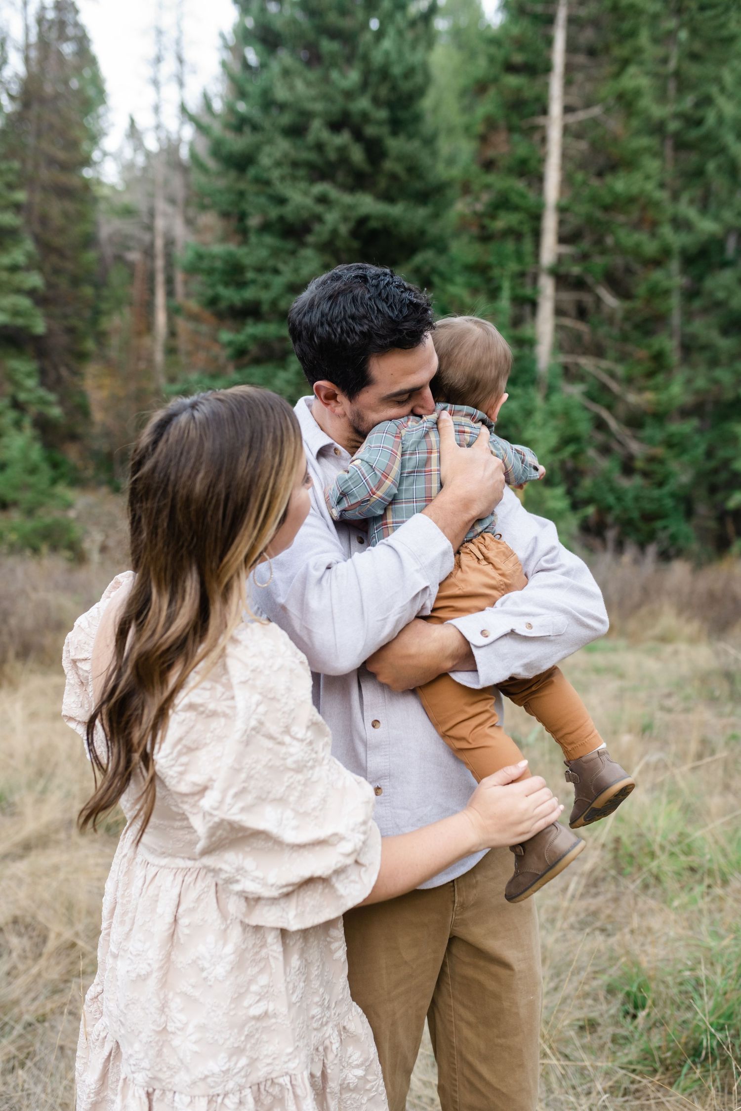 young family has a close cuddle together in American Fork Canyon for their fall family photos