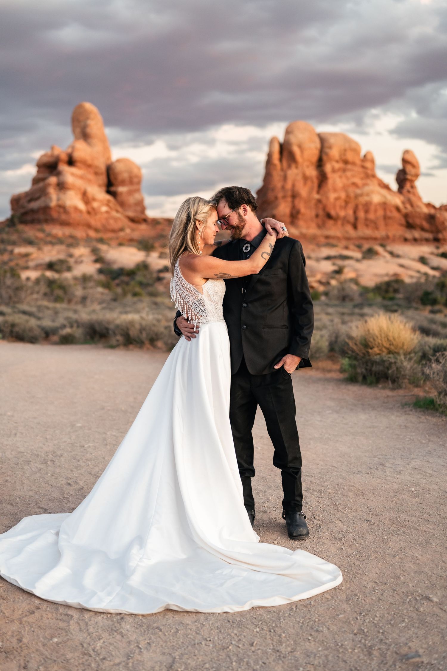 elopement couple close snuggle at Arches National Park by Utah Elopement Photographer