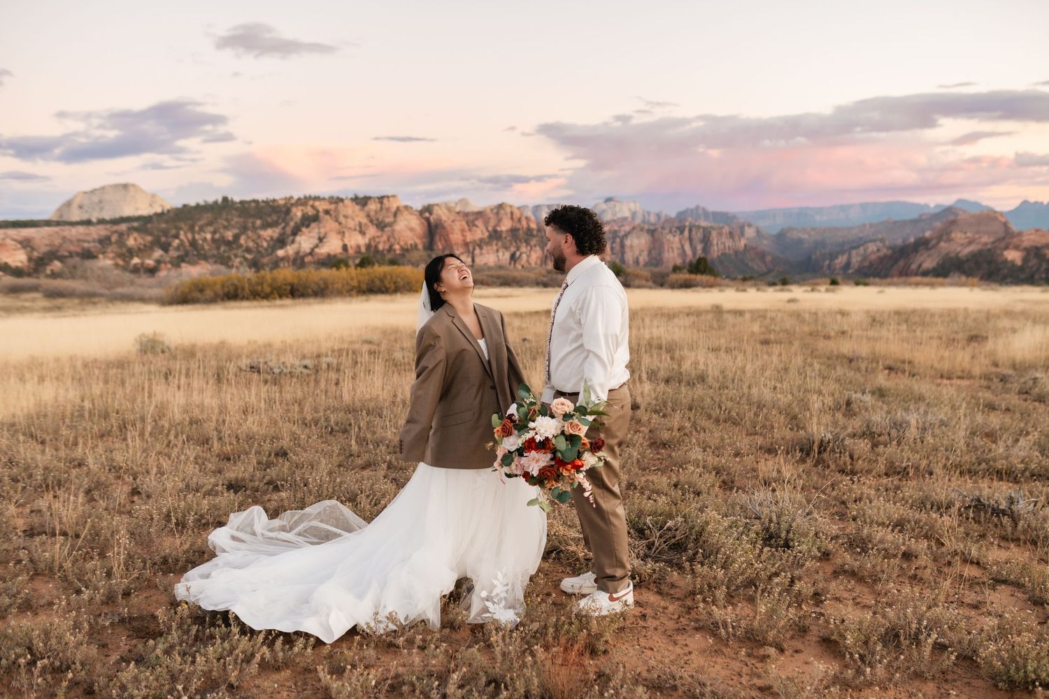 Scenic mountain vista with tall grass meadow during golden hour.