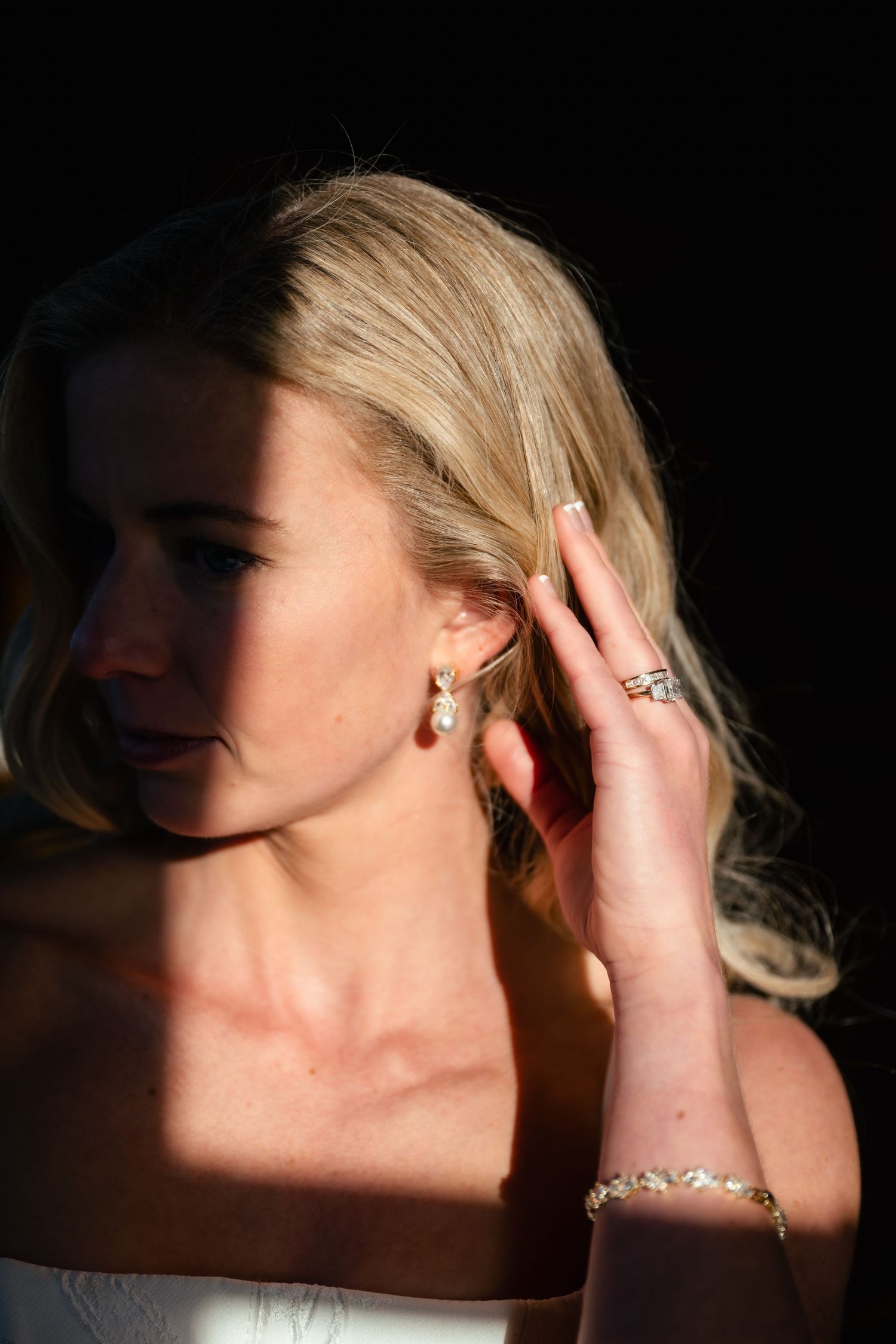 Artistic close-up portrait with dramatic lighting and shadows.
