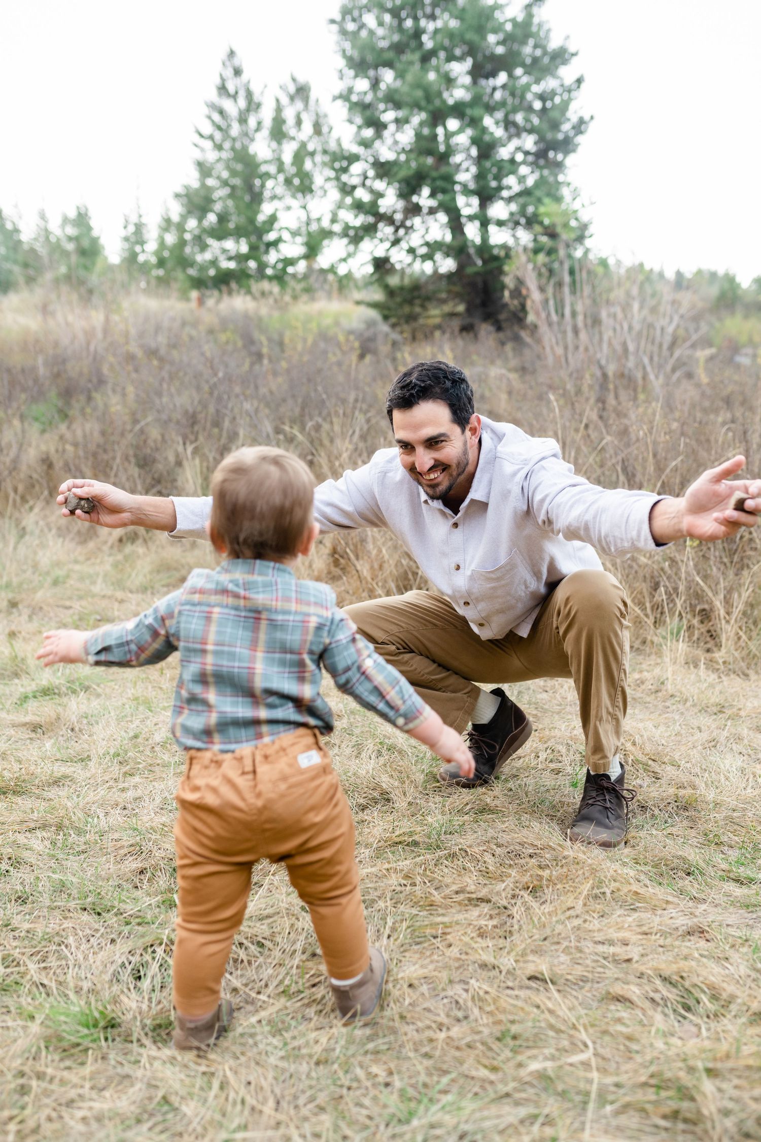 A sequence of playful falling poses captured in a grassy field on a sunny day.