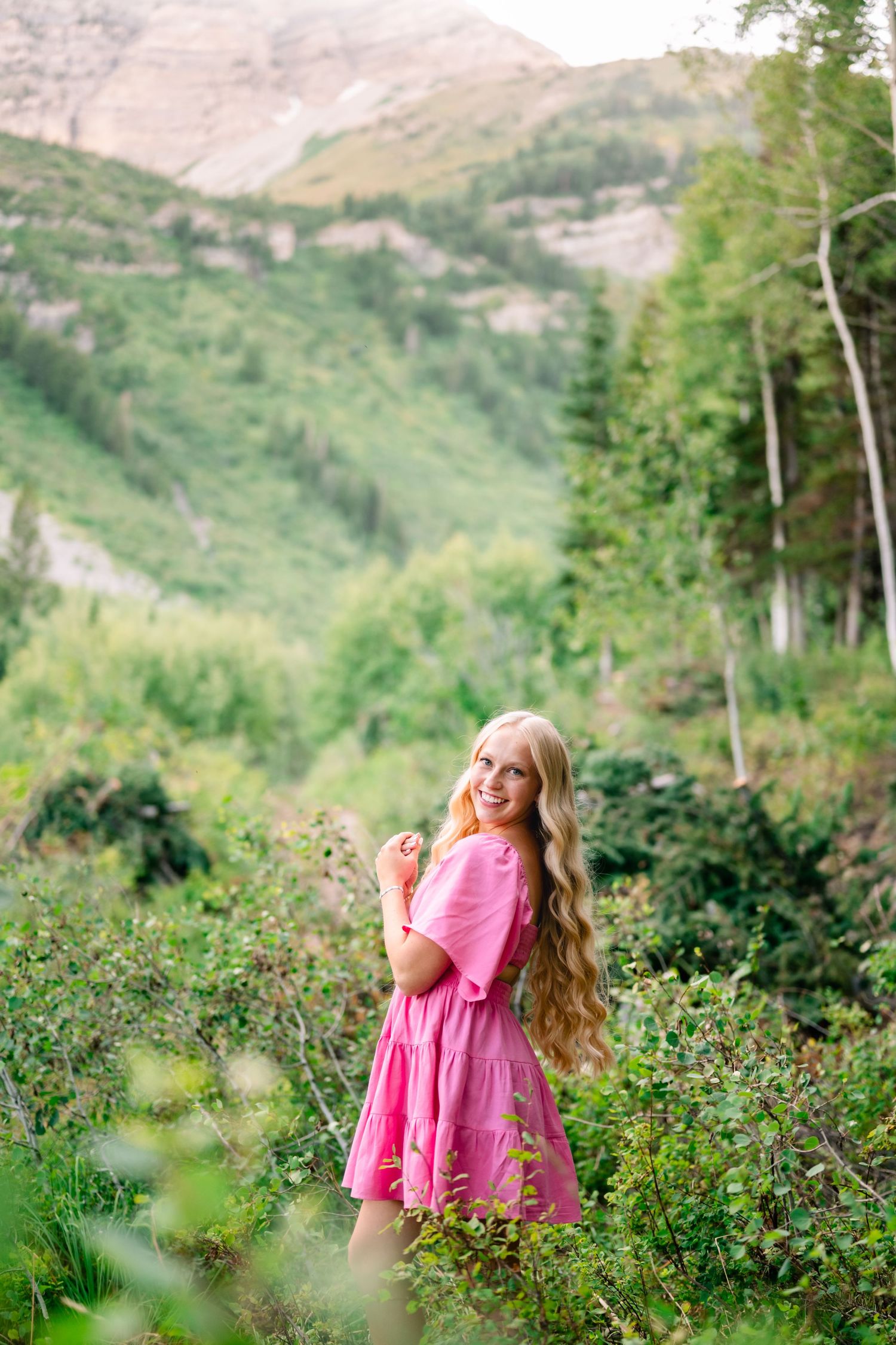 over the shoulder smiling portrait of a senior girl taken by Utah senior photographer