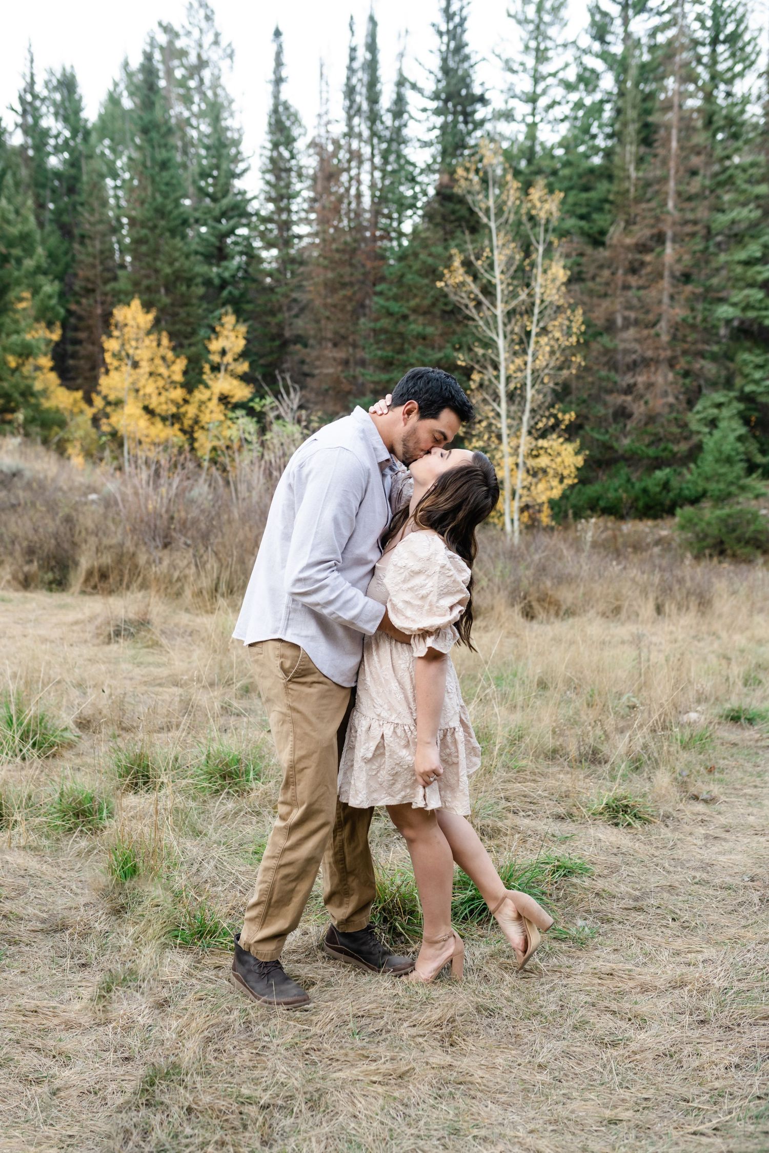 Husband and wife get portraits together young family has a close cuddle together during their fall family photos