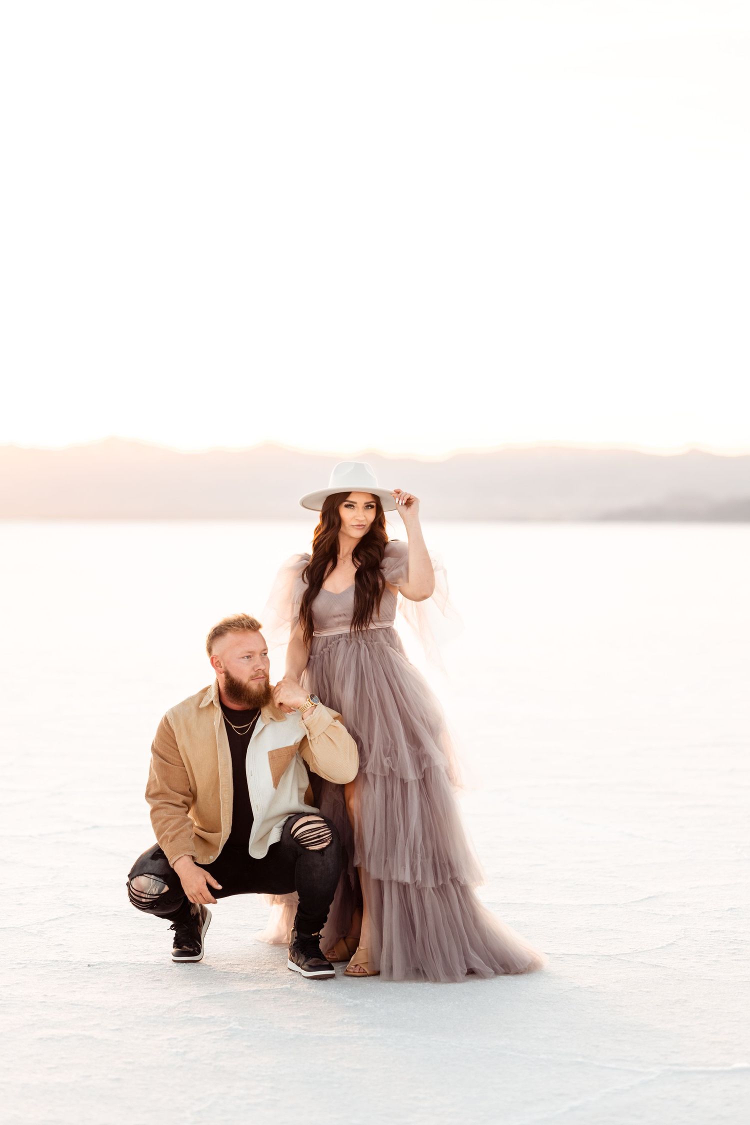 Couple hold each other during Salt Flats photos by Utah couples photographer during sunset