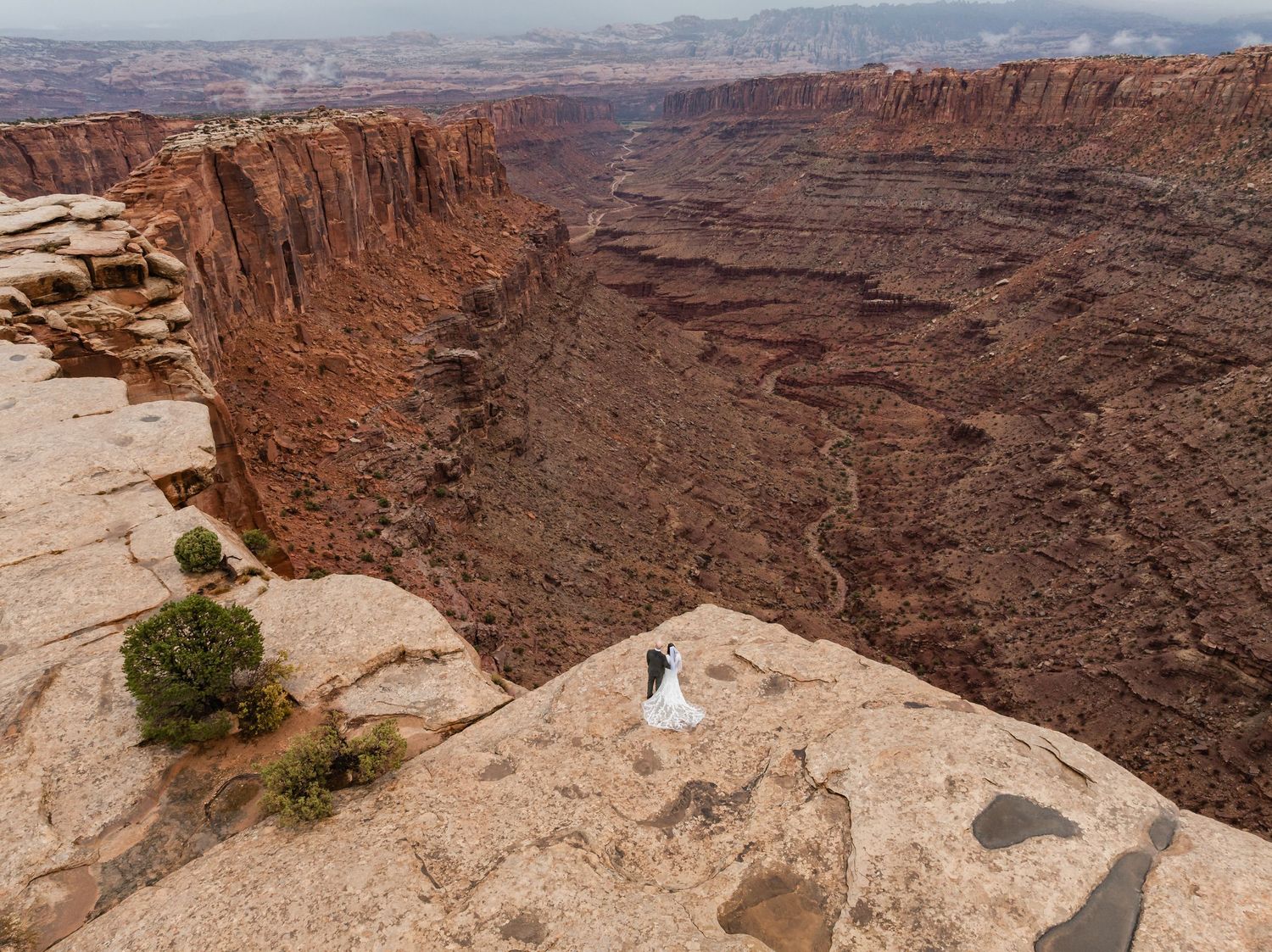A panoramic view of rugged red rock canyons and cliffs at Canyonlands National Park in Utah during sunset.