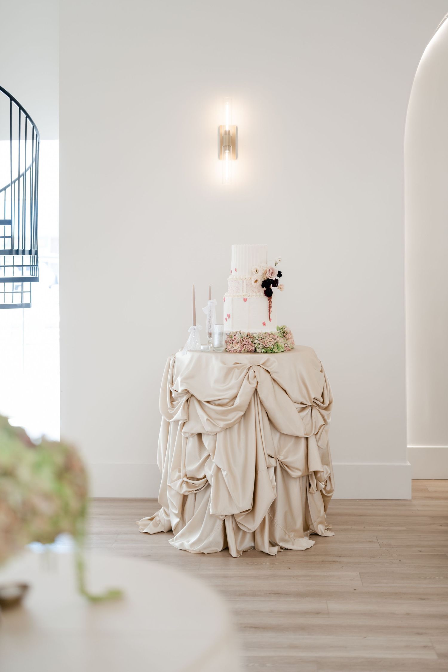 Elegant round table with draped cream-colored tablecloth and 3 tiered wedding cake by Baking Blonde. Utah Wedding Photographer.