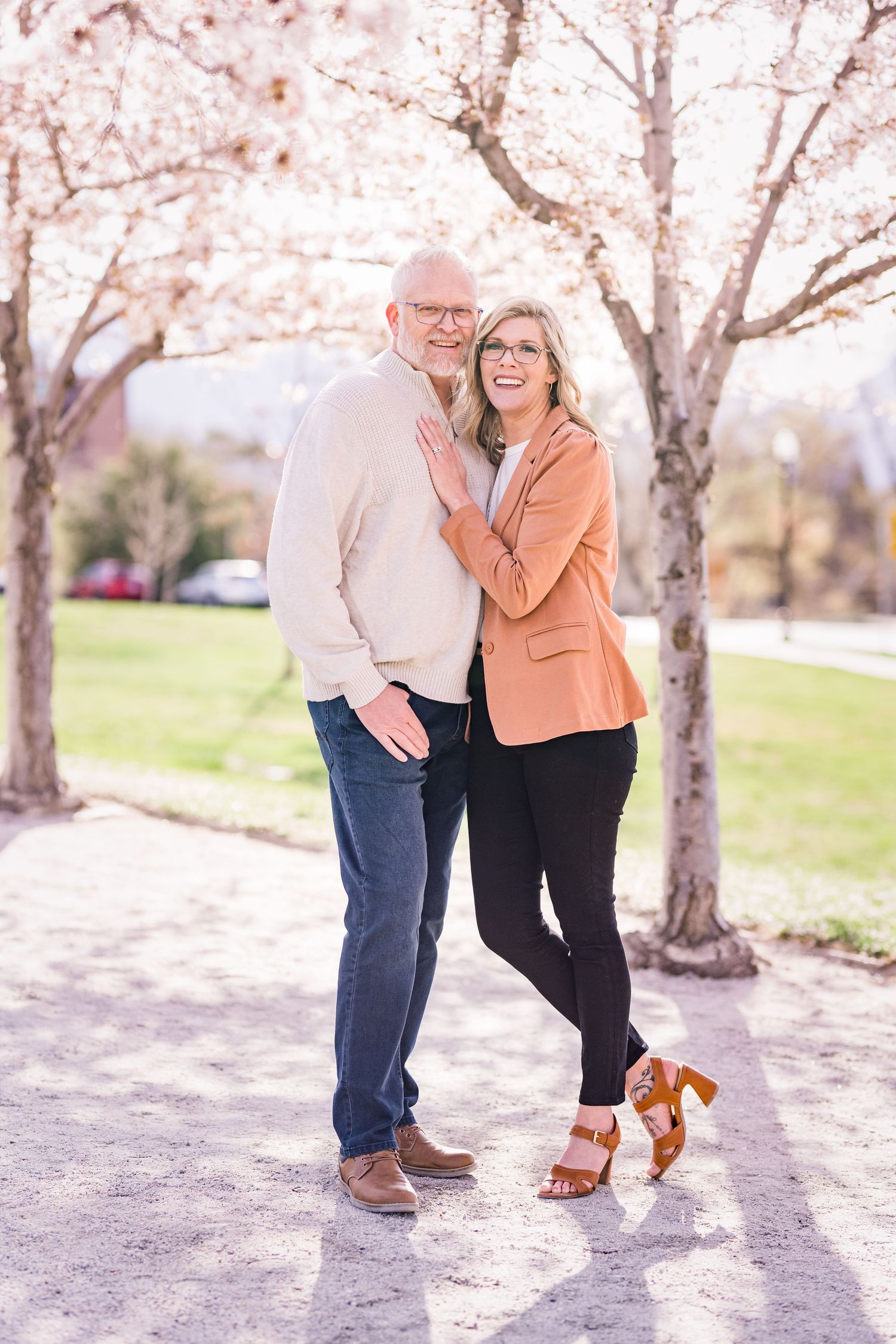 engaged couple smiling at the Capitol blossoms by Utah engagement photographer Coley Cook