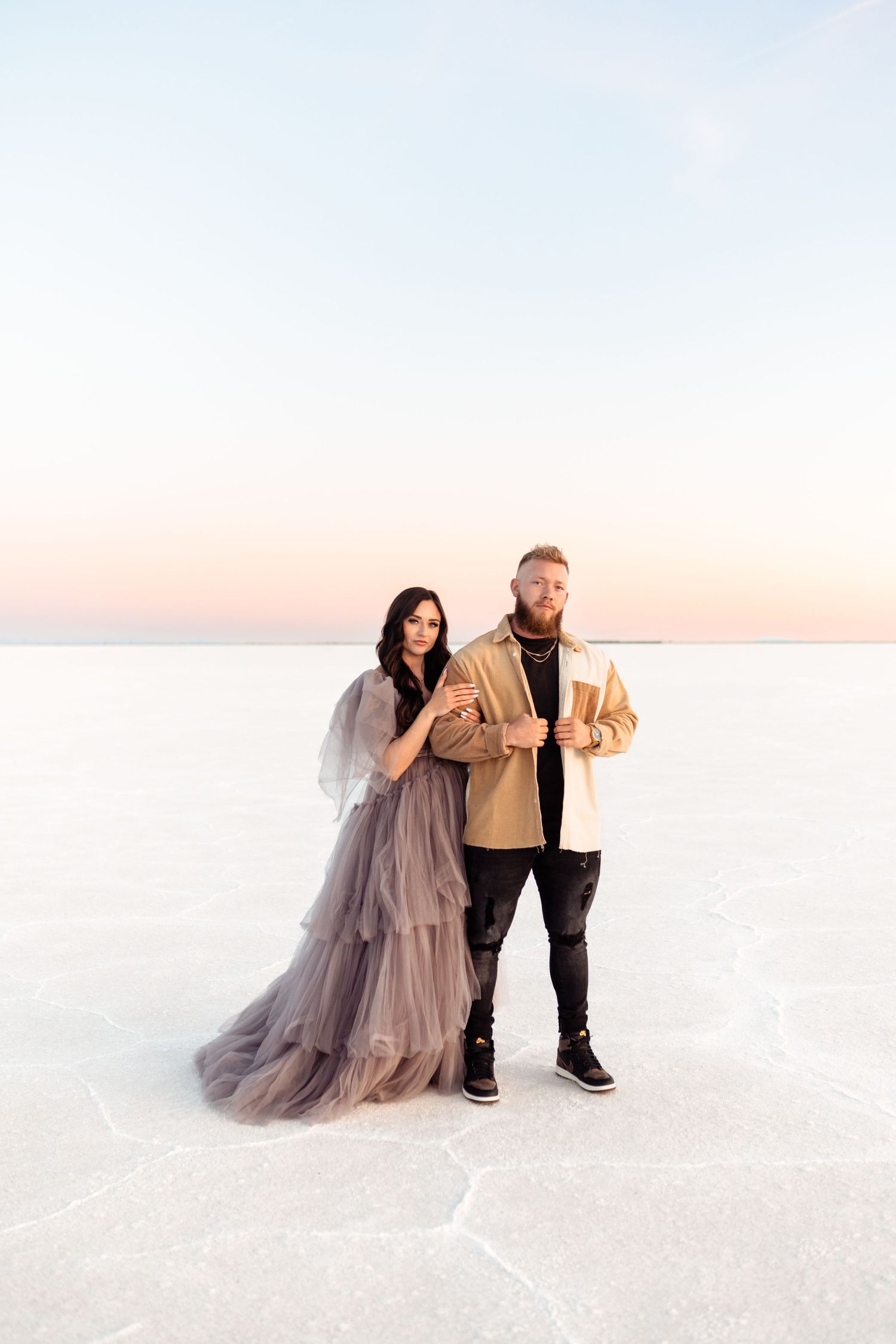 Couple hold each other during Salt Flats photos by Utah couples photographer during sunset