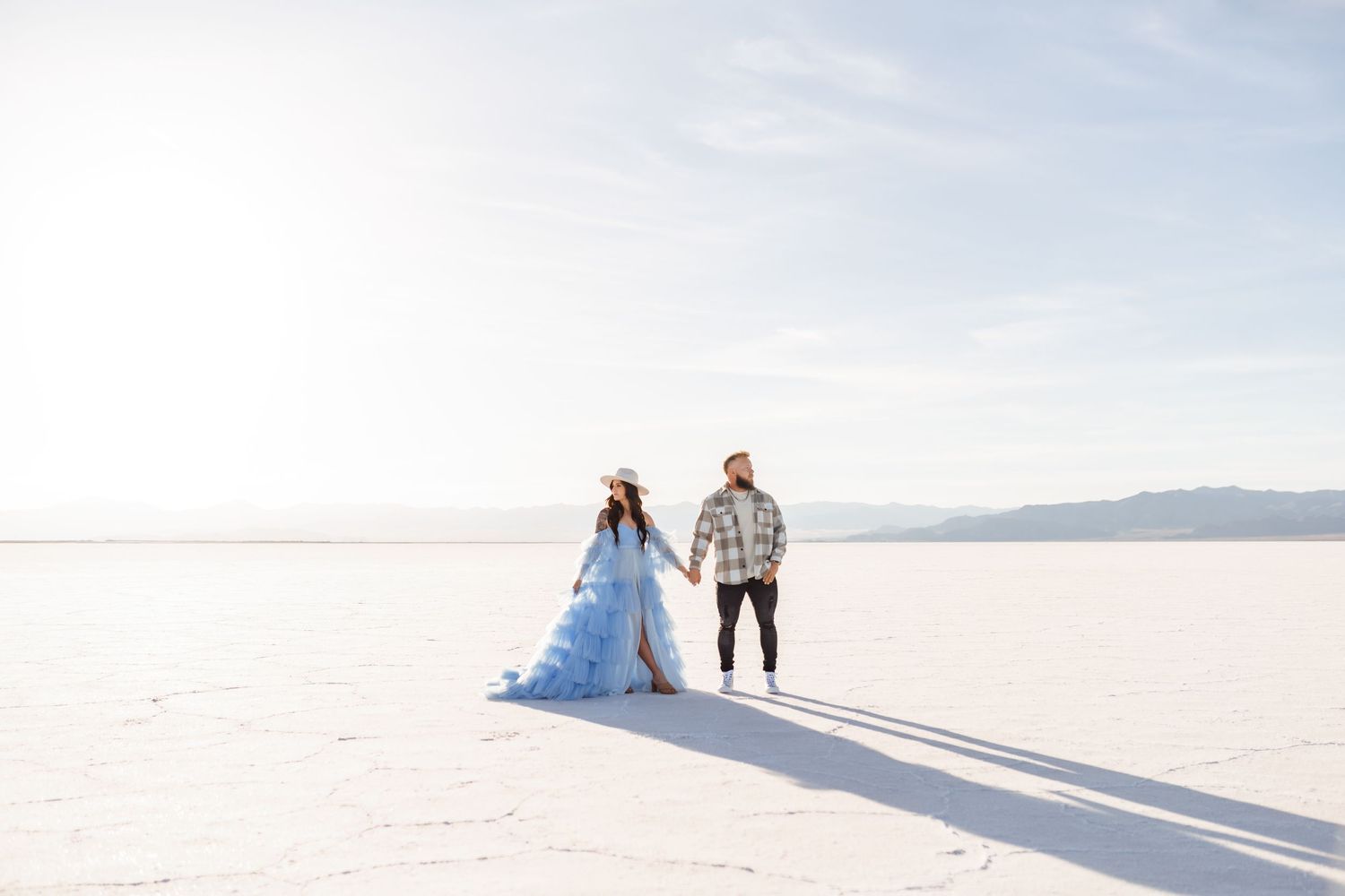 Couple holds hands during golden hour at the Salt Flats by Utah Salt Flats photographer