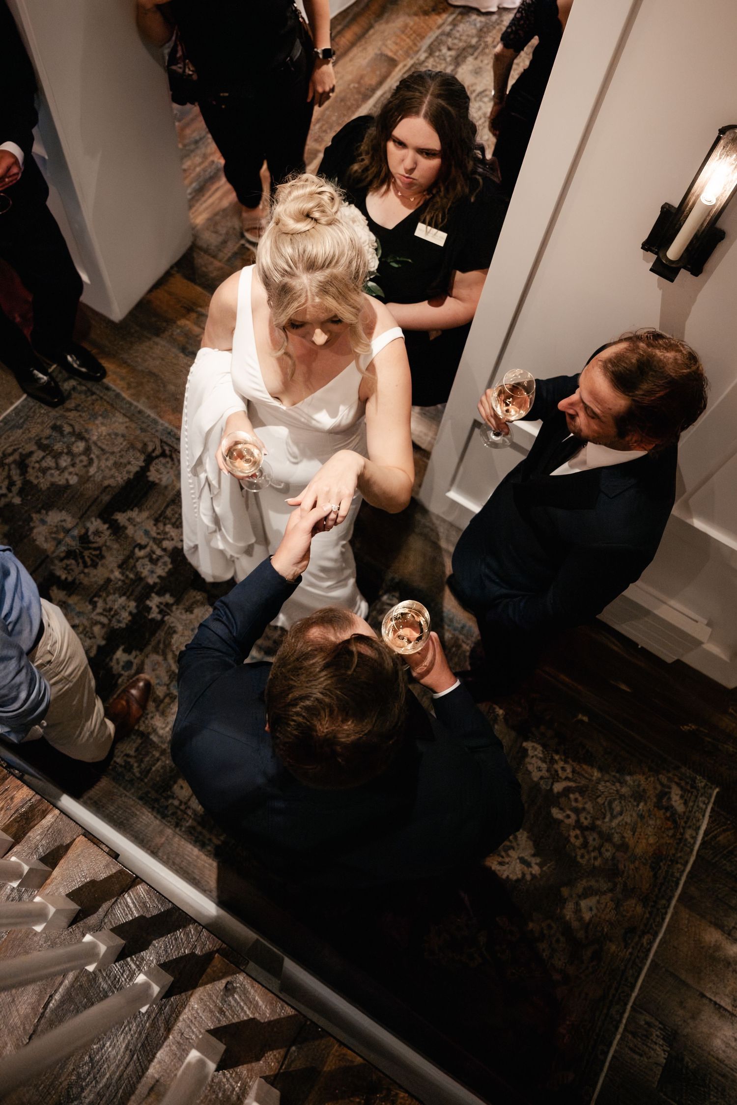 Wedding guests dancing and celebrating at an indoor reception venue.