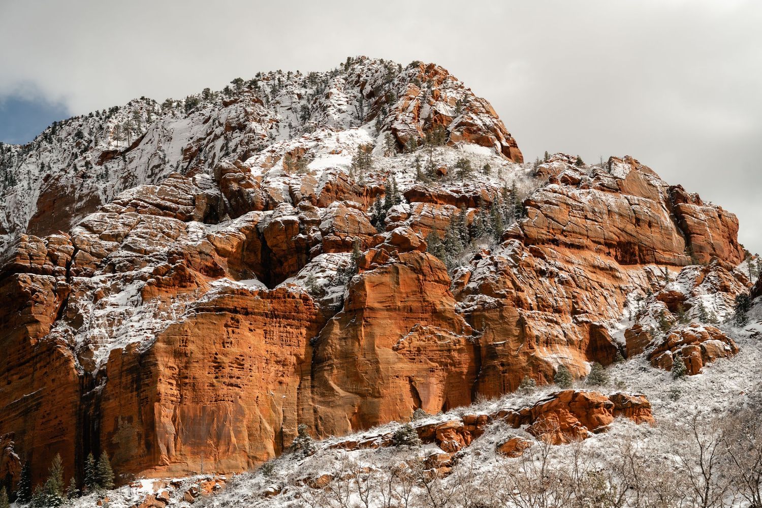 Snow-covered red rock formations at Garden of the Gods park create a dramatic winter landscape.