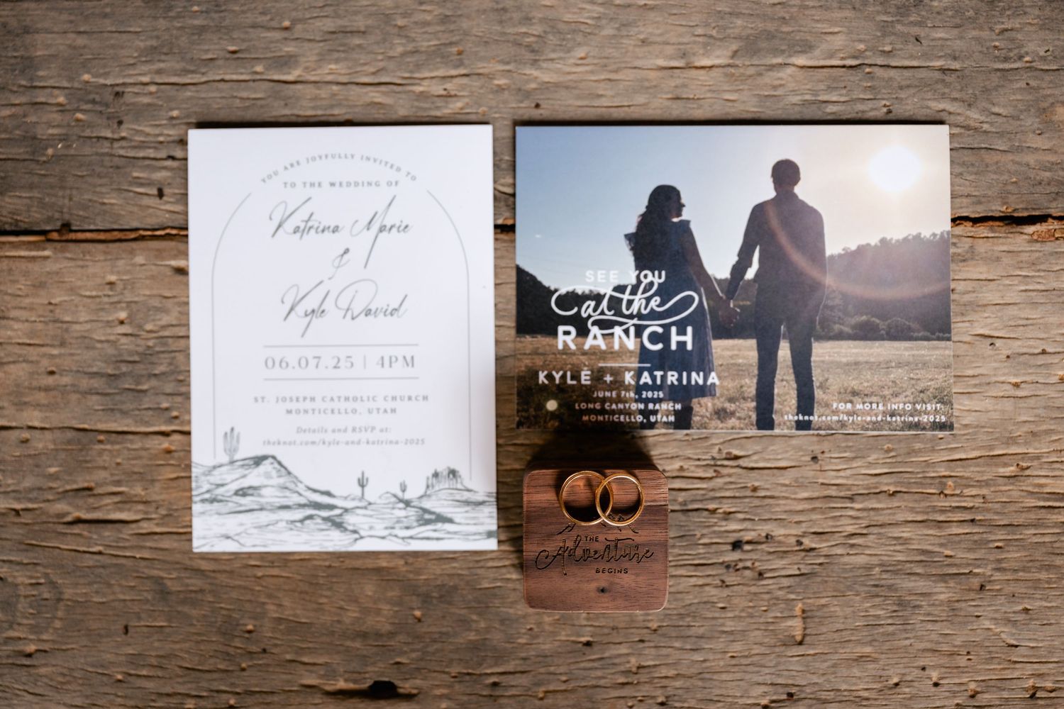 Wedding invitation suite with engagement photos displayed on rustic wooden background.