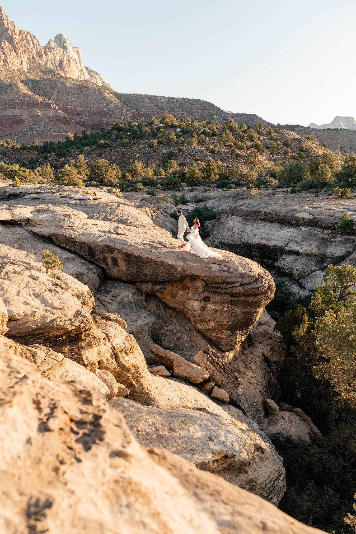 Zion Adventure Session. Desert wedding photography showcasing dramatic rock formations and natural landscape at sunset.