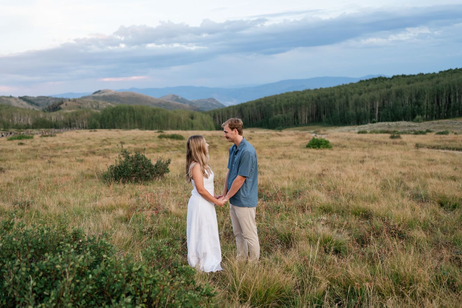 Couple holds hands during their Park City engagement photos at Guardsman Pass at sunset. Location near Deer Valley.