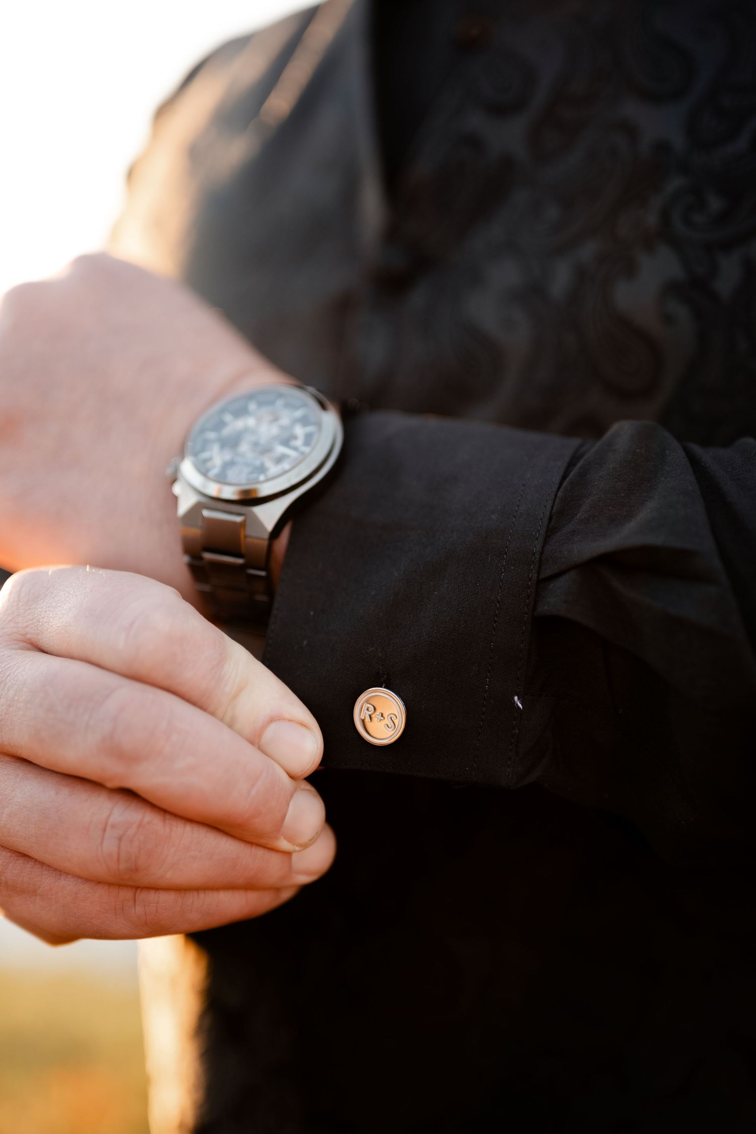 Close-up sequence of hands exchanging wedding rings during a sunset ceremony.