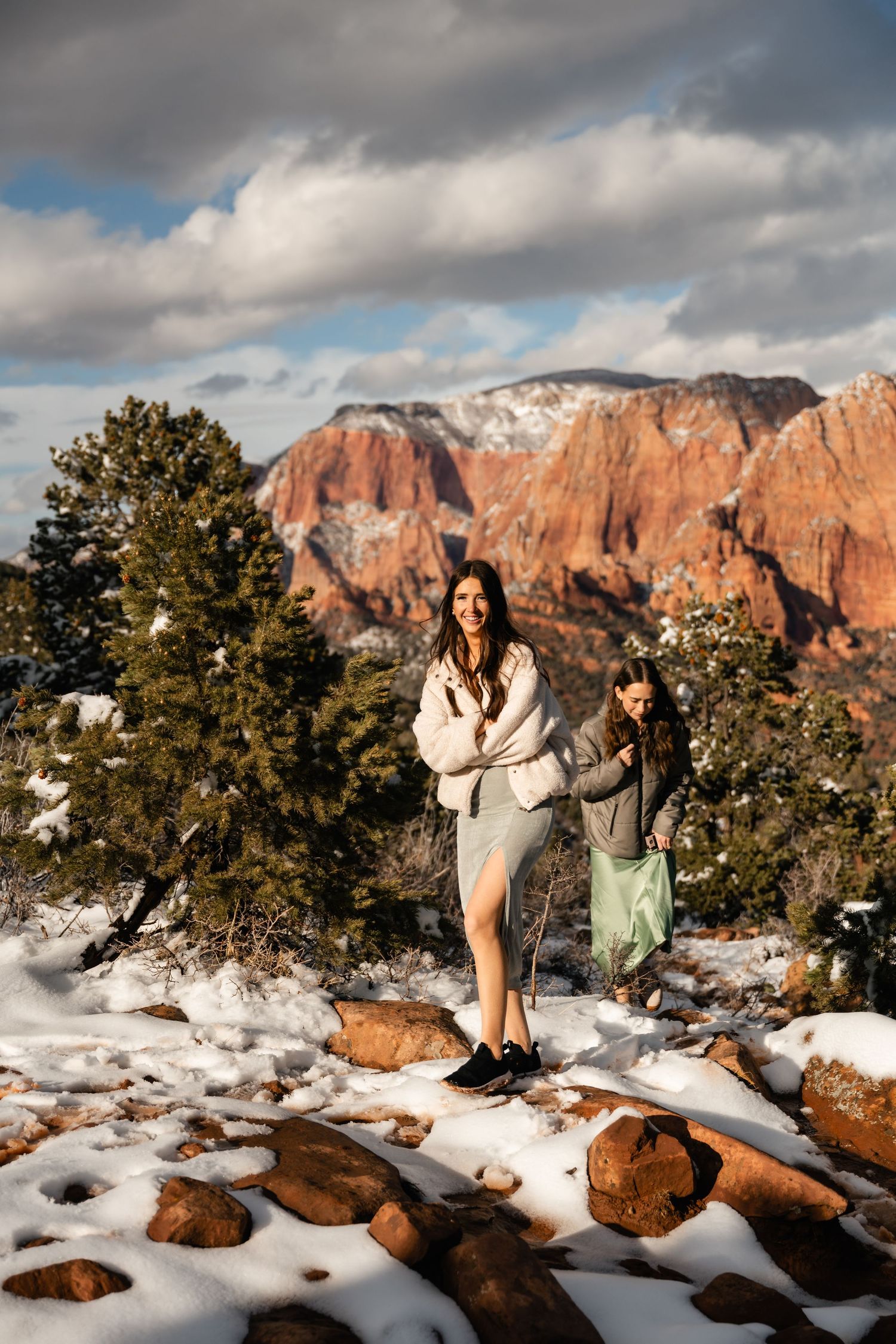Snow-covered red rock landscape with dramatic mountain peaks and evergreen trees in Kolob Canyons.