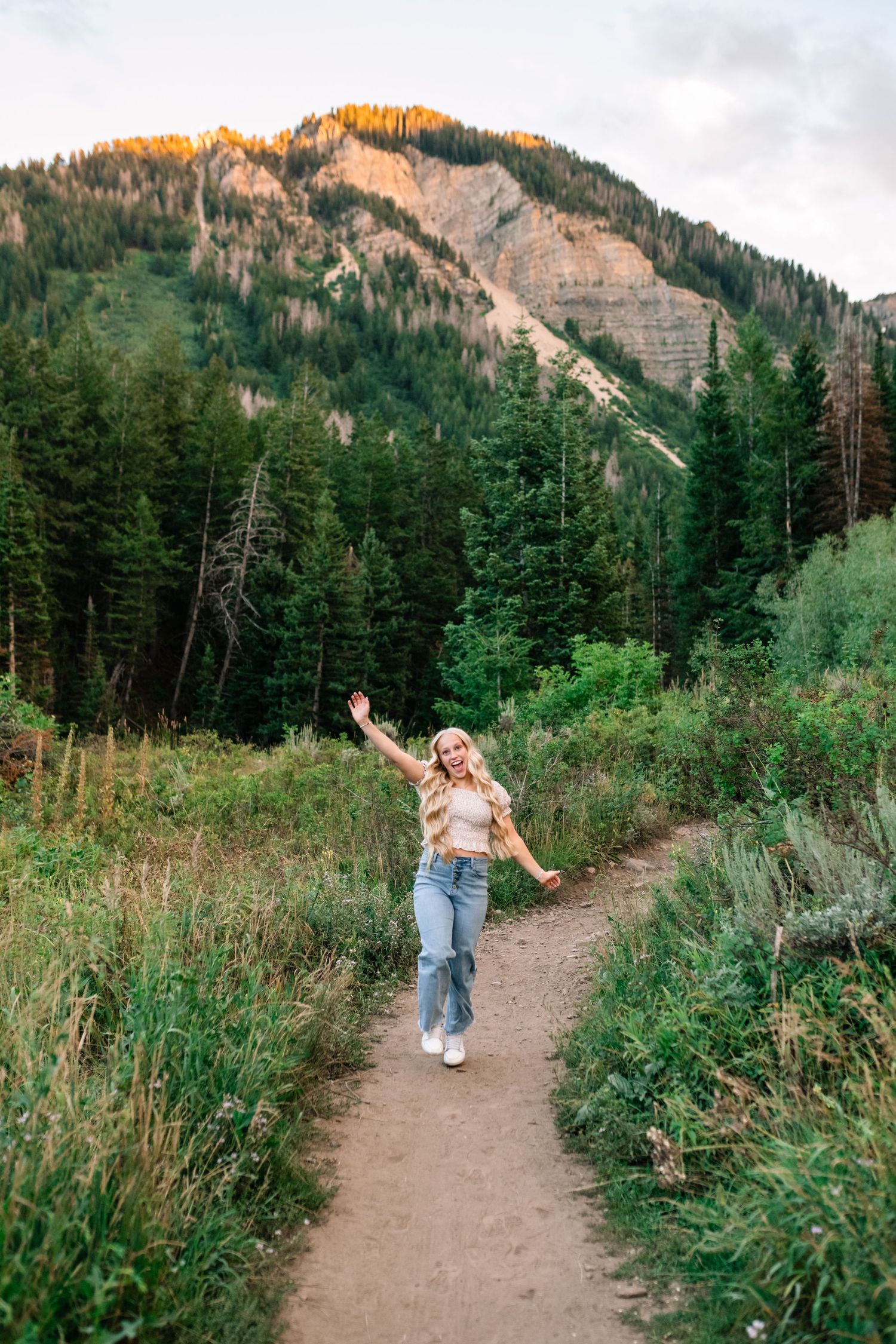 senior girl dancing in the mountains during her senior photo session