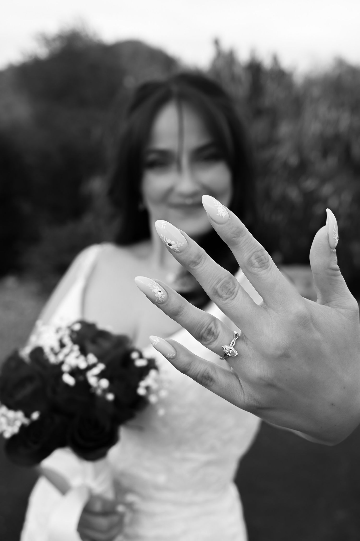 A series of black and white photos showing hands with engagement rings and wedding bouquets.