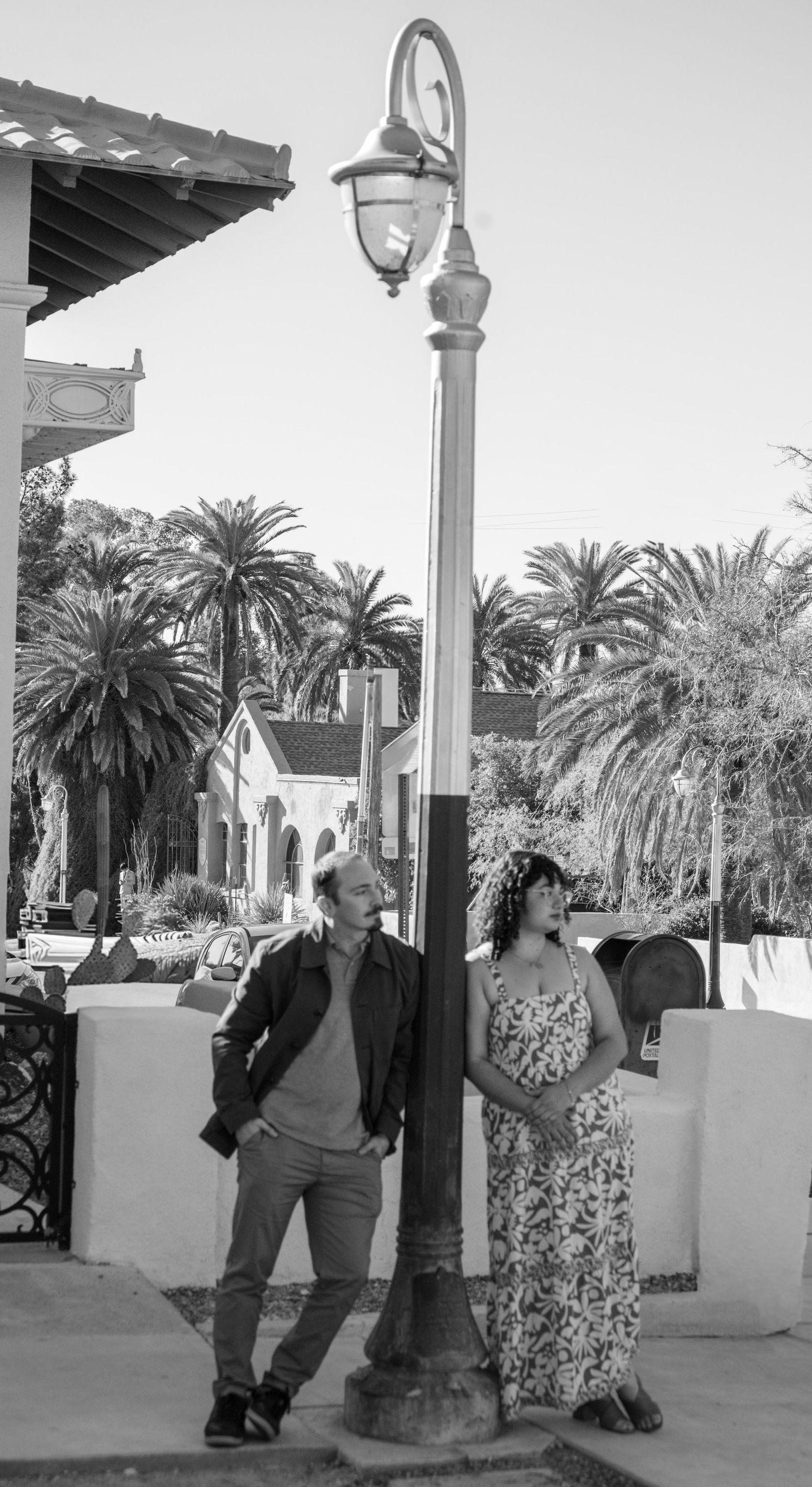A series of black and white photos showing people dancing and posing near ornate lamp posts and palm trees.