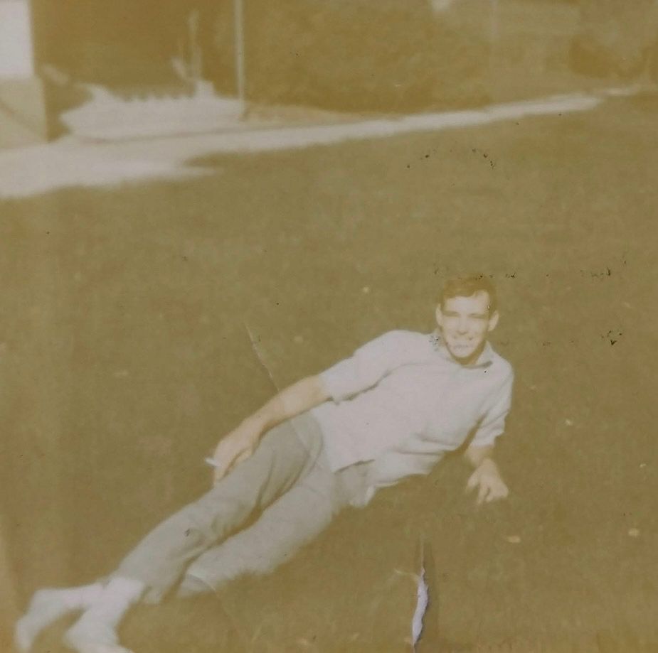 Vintage black and white photograph showing someone performing a series of tumbling or rolling motions on grass.